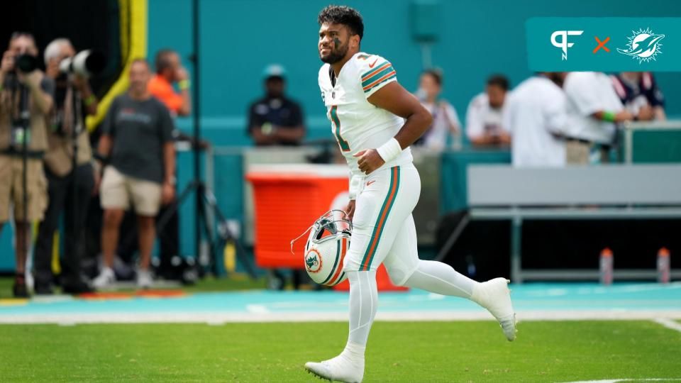 Miami Dolphins quarterback Tua Tagovailoa (1) runs onto the field prior to the game against the New England Patriots at Hard Rock Stadium.