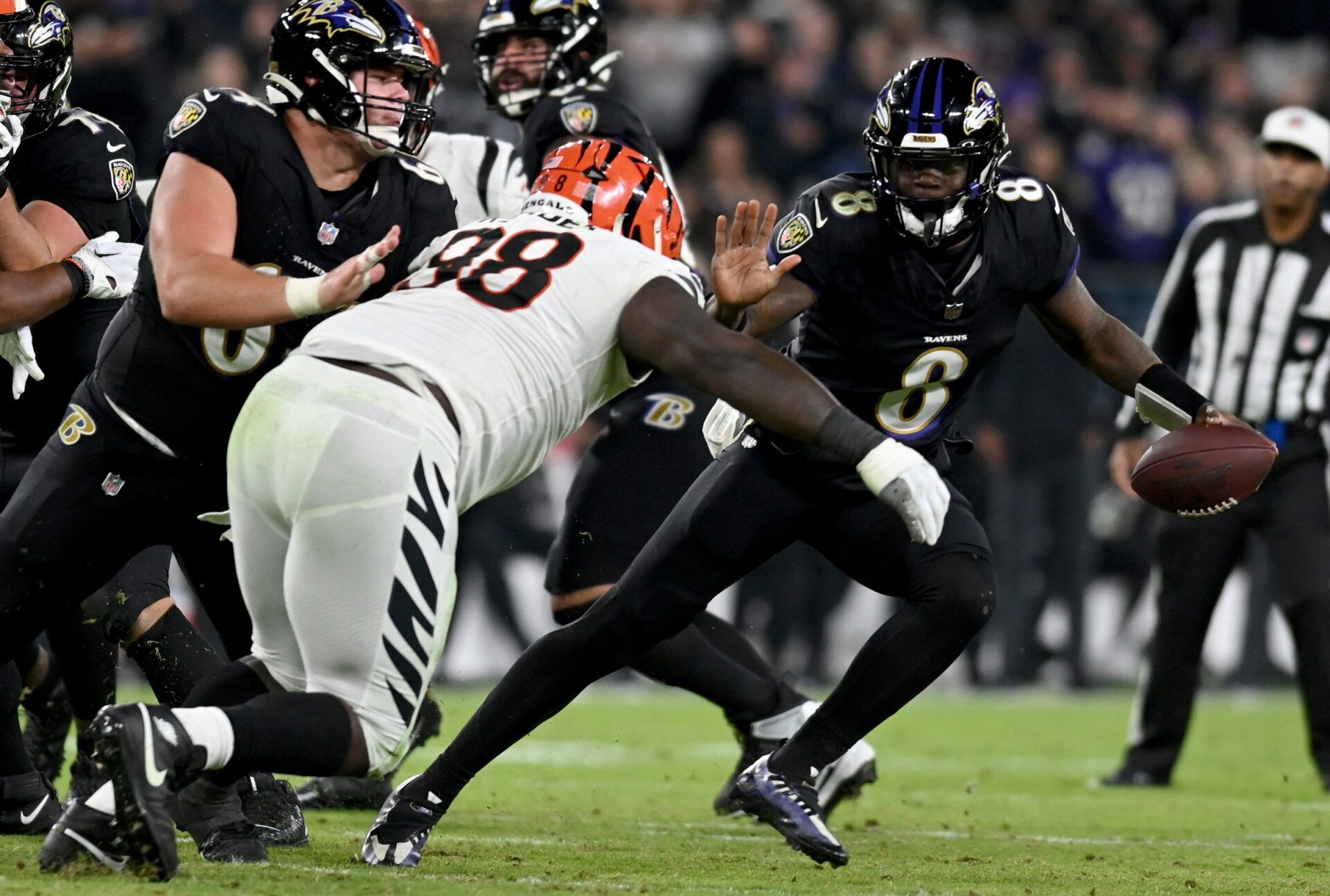 Lamar Jackson (8), quarterback of the AFC North-winning Baltimore Ravens, runs with the football against the Cincinnati Bengals.