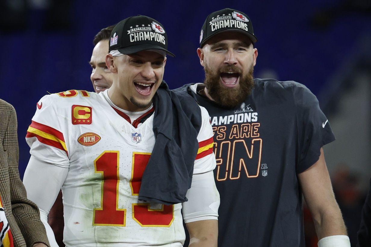 Kansas City Chiefs quarterback Patrick Mahomes (15) and Chiefs tight end Travis Kelce (R) celebrate on the stage prior to the trophy presentation after their' game against the Baltimore Ravens in the AFC Championship football game at M&T Bank Stadium. Mandatory Credit: Geoff Burke-USA TODAY Sports