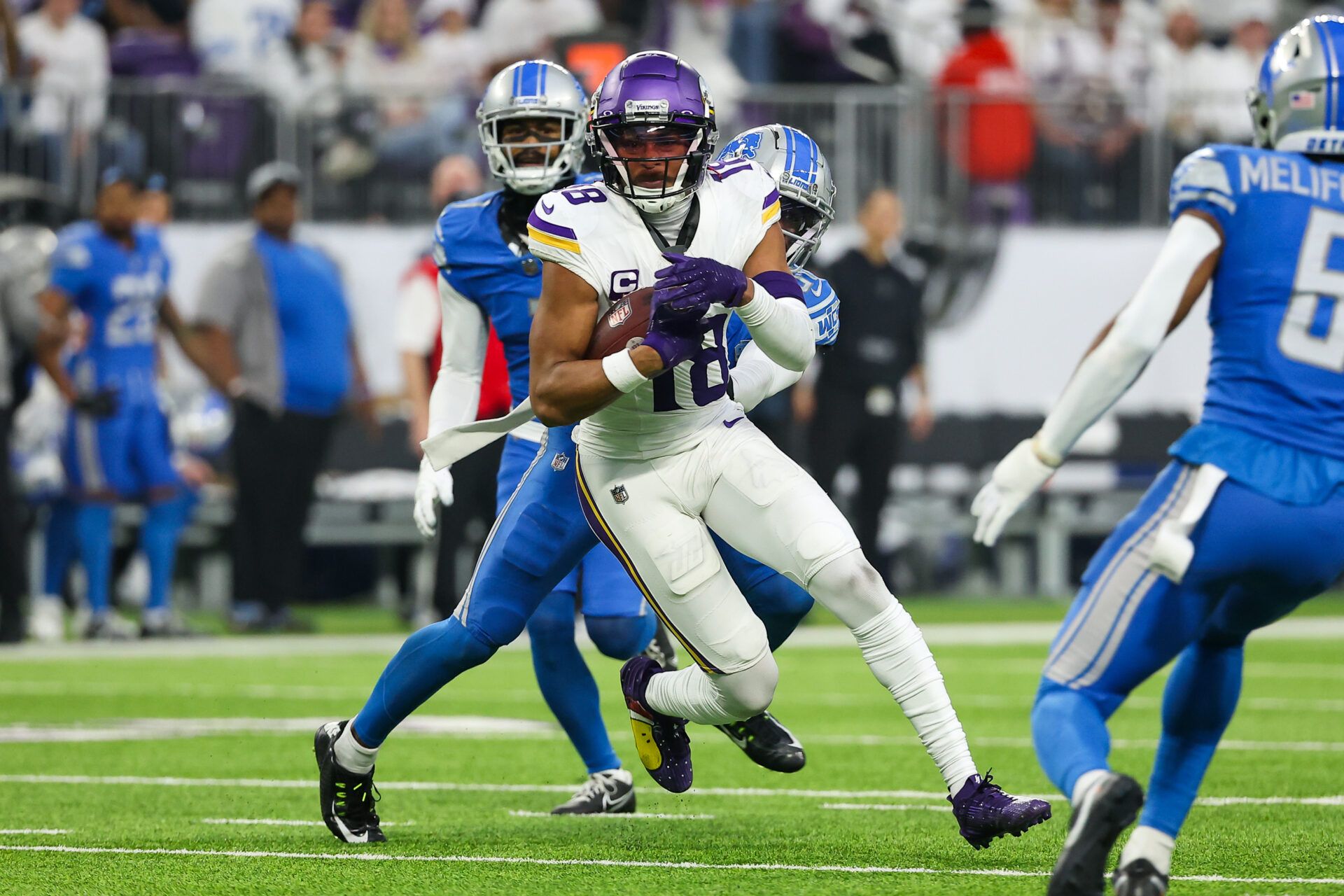 Minnesota Vikings wide receiver Justin Jefferson (18) runs the ball after a catch against the Detroit Lions during the second quarter at U.S. Bank Stadium.