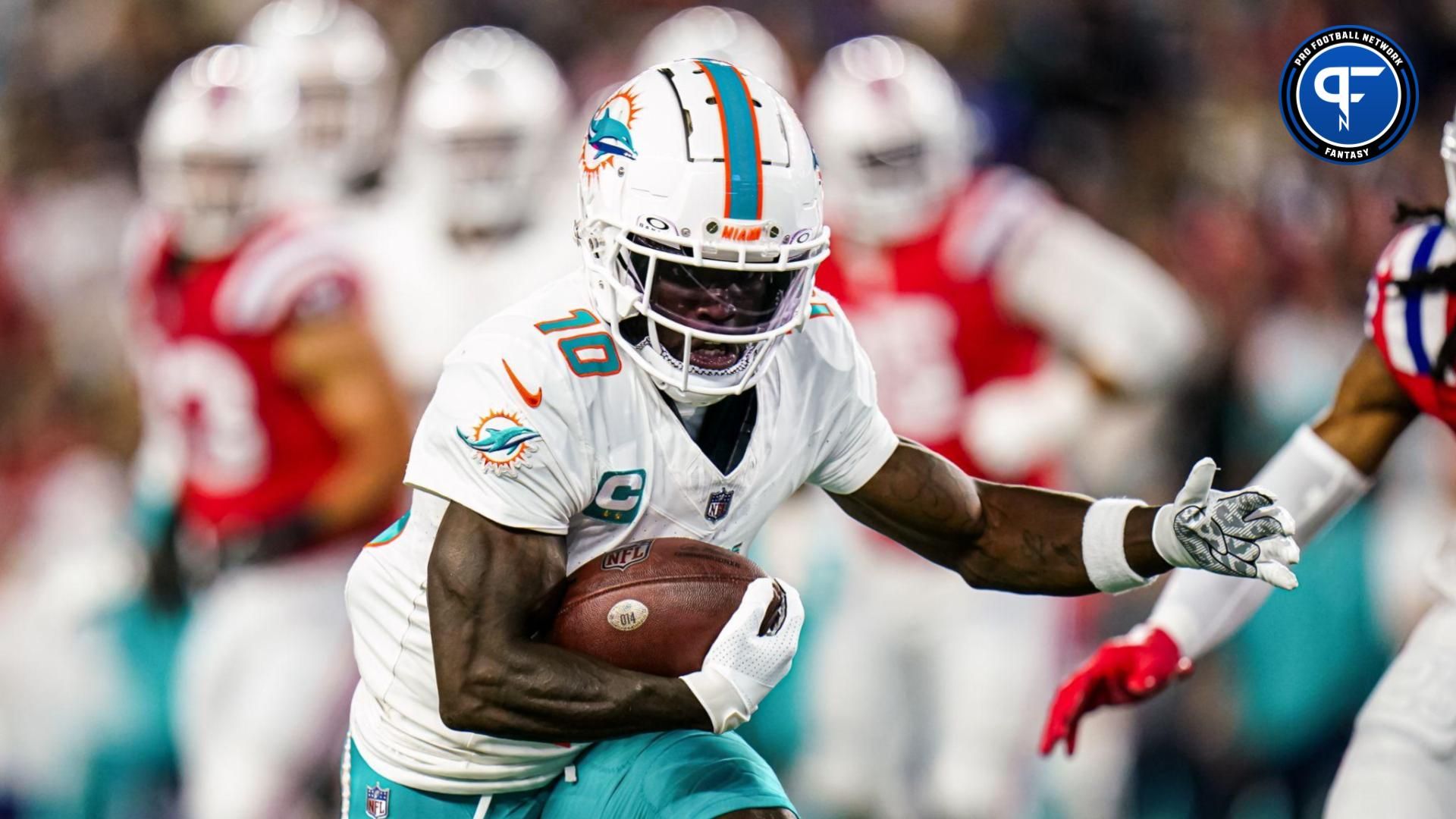 Miami Dolphins wide receiver Tyreek Hill (10) runs the ball against the New England Patriots in the first quarter at Gillette Stadium.