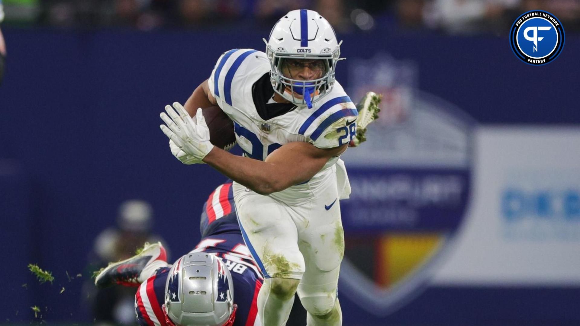 Indianapolis Colts running back Jonathan Taylor (28) breaks a tackle from New England Patriots cornerback Myles Bryant (27) in the second quarter during an International Series game at Deutsche Bank Park. Mandatory Credit: Nathan Ray Seebeck-USA TODAY Sports