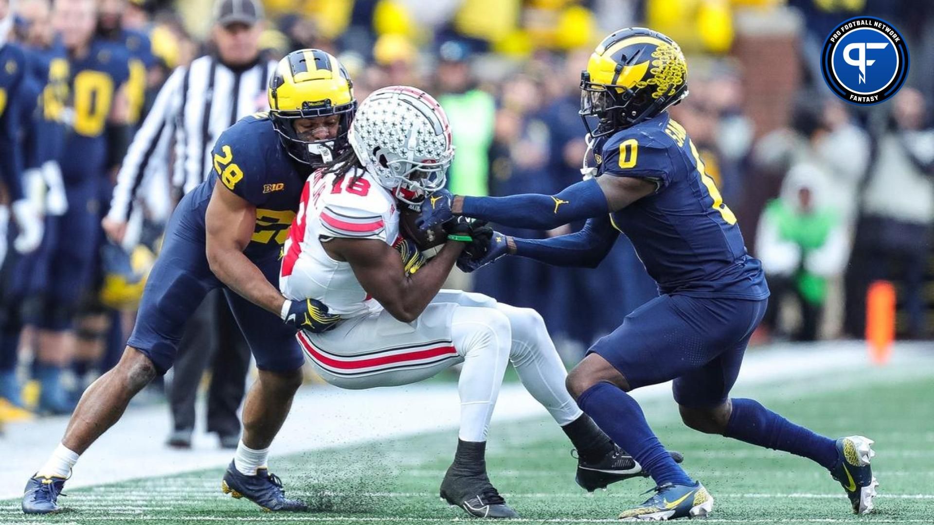 Ohio State wide receiver Marvin Harrison Jr. (18) makes a catch against Michigan defensive back Quinten Johnson (28) and defensive back Mike Sainristil (0) during the second half at Michigan Stadium in Ann Arbor on Saturday, Nov. 25, 2023.