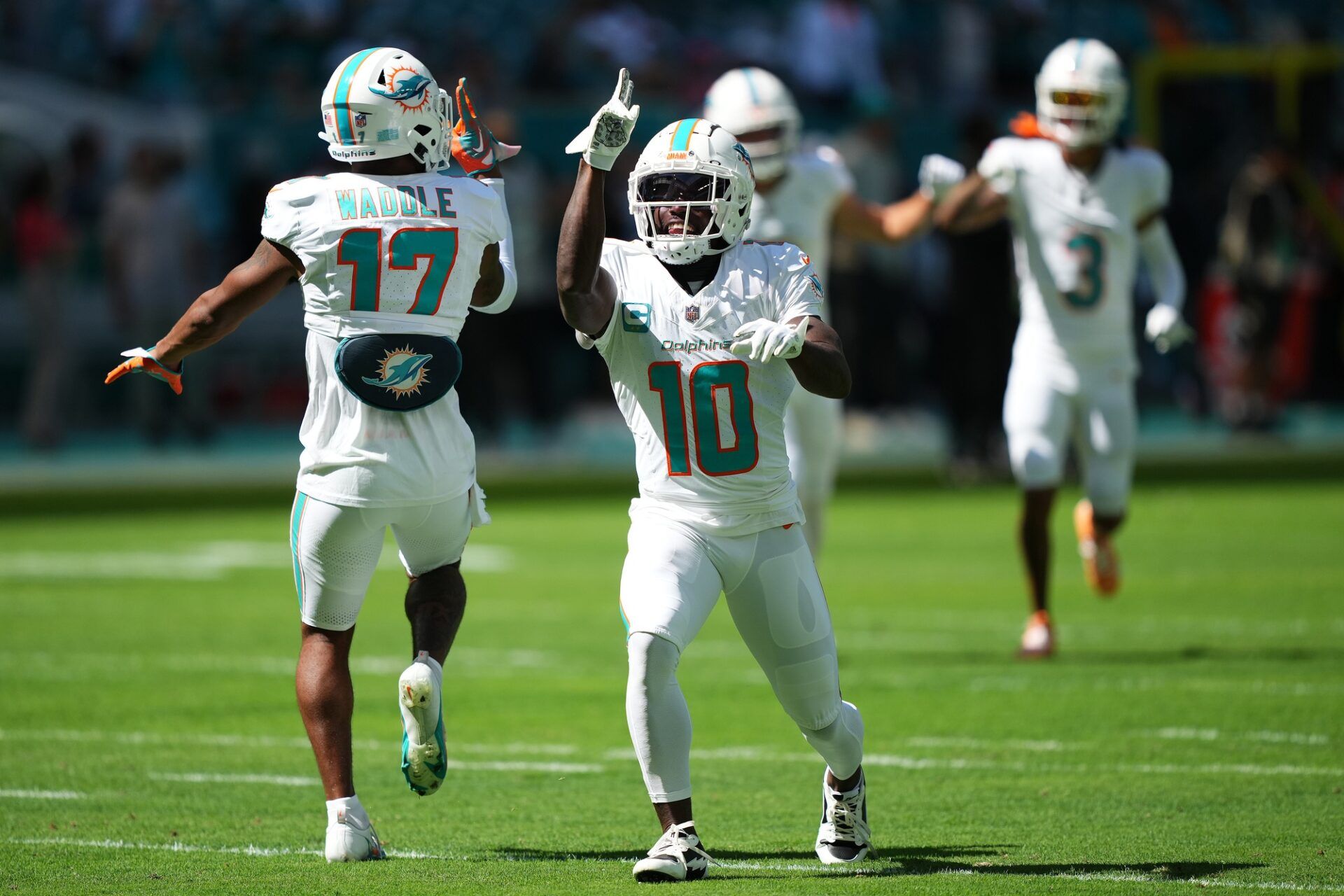 One of the NFL's best WR duos, the Miami Dolphins' Jaylen Waddle (17) and Tyreek Hill (10) celebrate during a game against the Carolina Panthers.