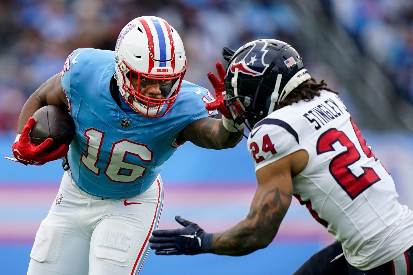 Tennessee Titans wide receiver Treylon Burks (16) stiff arms Houston Texans cornerback Derek Stingley Jr. (24) during the fourth quarter at Nissan Stadium in Nashville, Tenn., Sunday, Dec. 17, 2023.