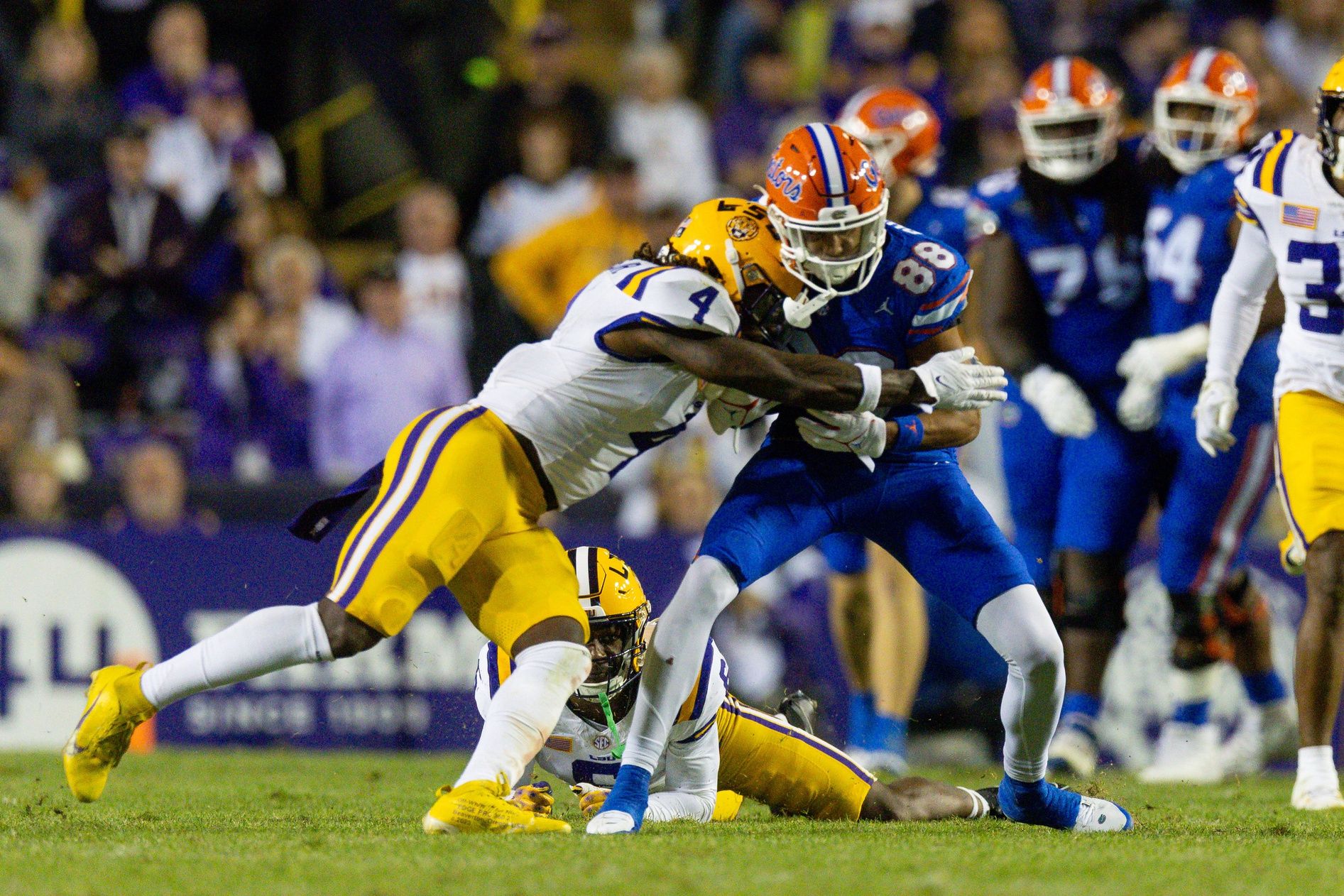 LSU Tigers LB Harold Perkins (4) tackles Florida Gators WR Marcus Burke (88).