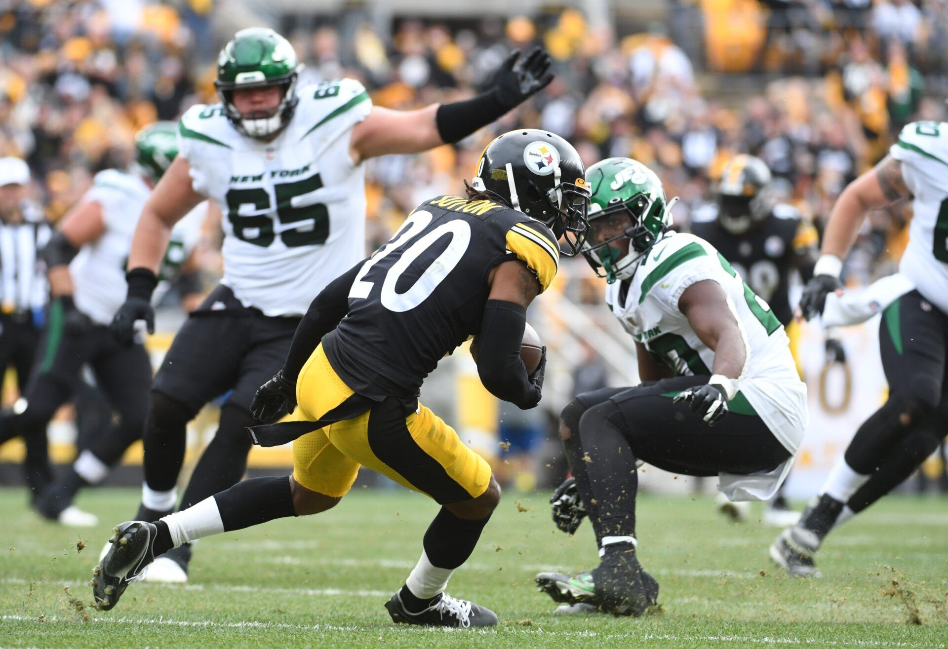 Pittsburgh Steelers cornerback Cam Sutton (20) runs past New York Jets running back Breece Hall (20) after intercepting a pass during the second quarter at Acrisure Stadium.