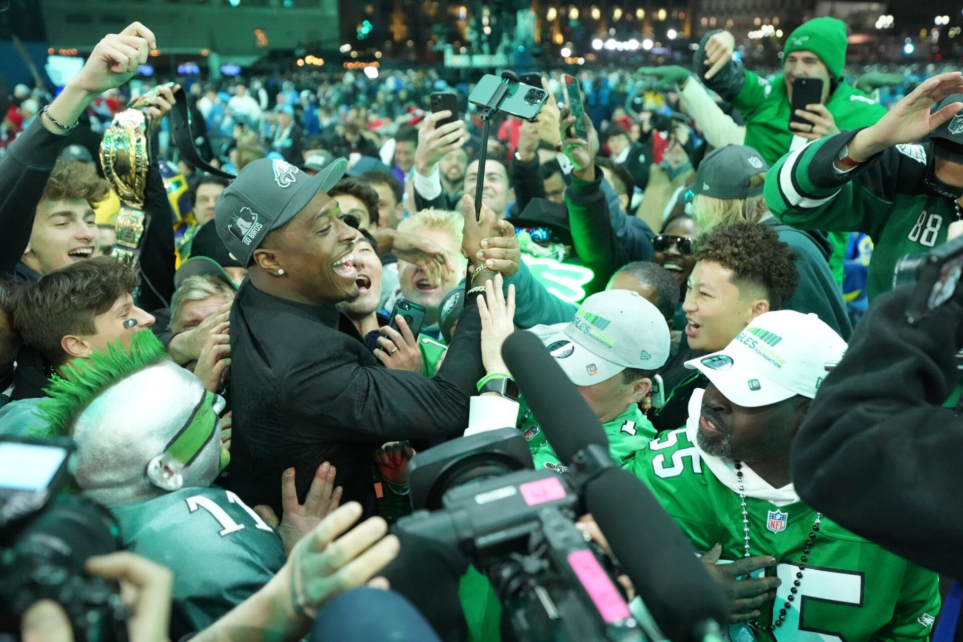 Toledo Rockets cornerback Quinyon Mitchell poses with fans after being selected by the Philadelphia Eagles as the No. 22 pick in the first round of the 2024 NFL Draft at Campus Martius Park and Hart Plaza.