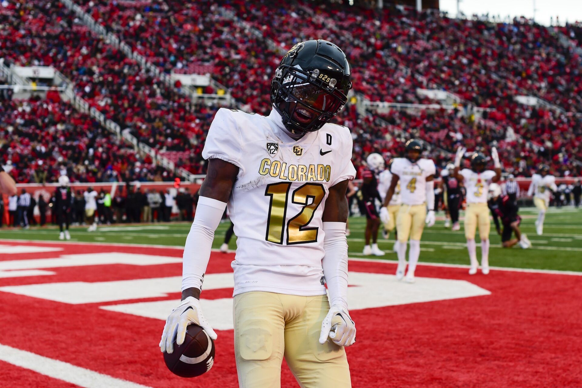 Colorado Buffaloes athlete Travis Hunter (12) reacts after scoring a touchdown against the Utah Utes at Rice-Eccles Stadium. Mandatory Credit: Christopher Creveling-USA TODAY Sports