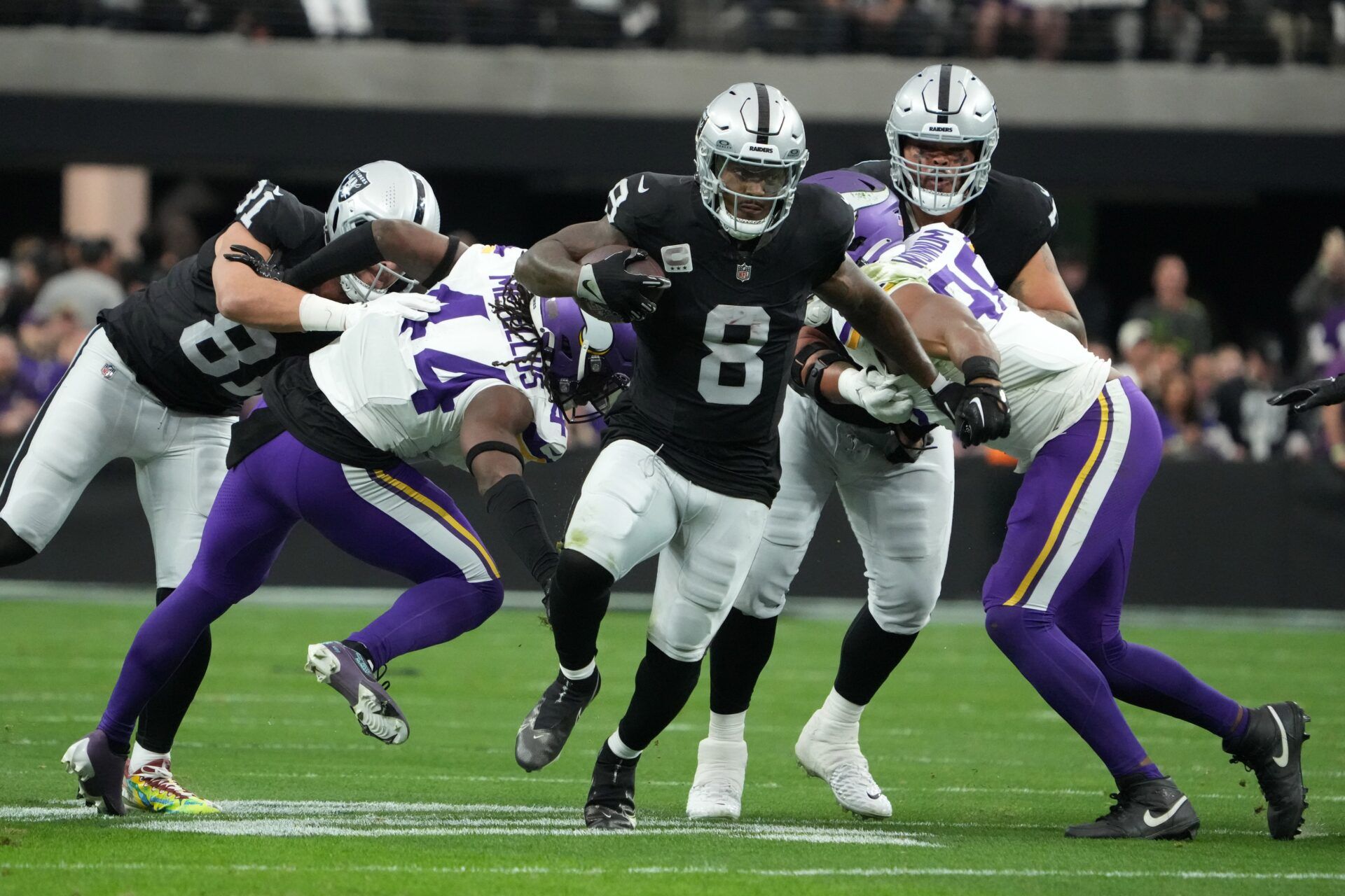 Las Vegas Raiders running back Josh Jacobs (8) carries the ball against the Minnesota Vikings in the first half at Allegiant Stadium.