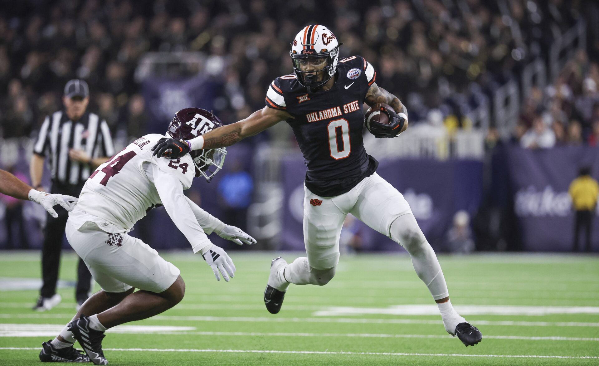 Oklahoma State Cowboys running back Ollie Gordon II (0) runs with the ball as Texas A&M Aggies linebacker Chris Russell Jr. (24) attempts to make a tackle during the first quarter at NRG Stadium.