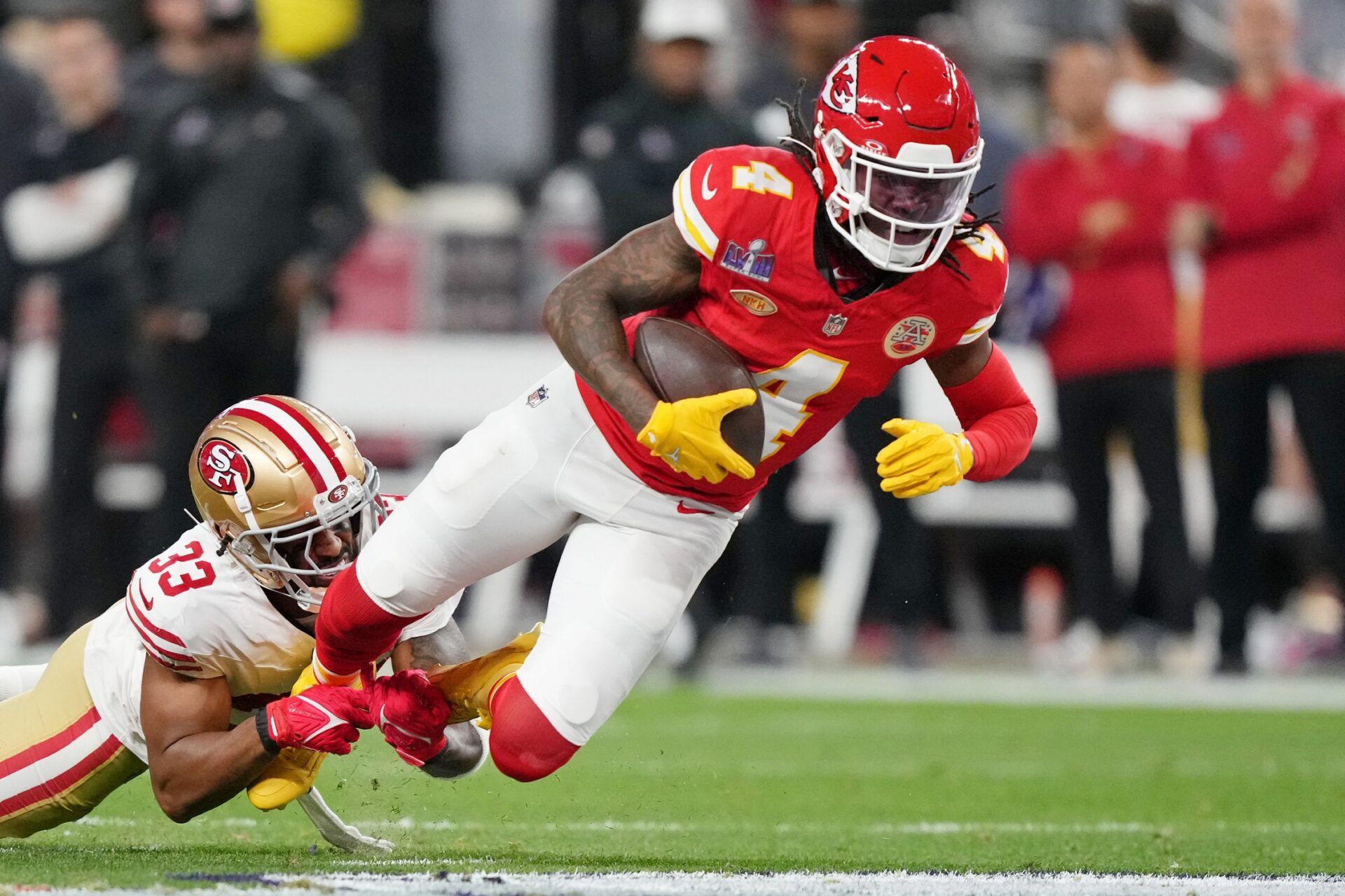 Kansas City Chiefs WR Rashee Rice (4) fights for extra yardage against the San Francisco 49ers.