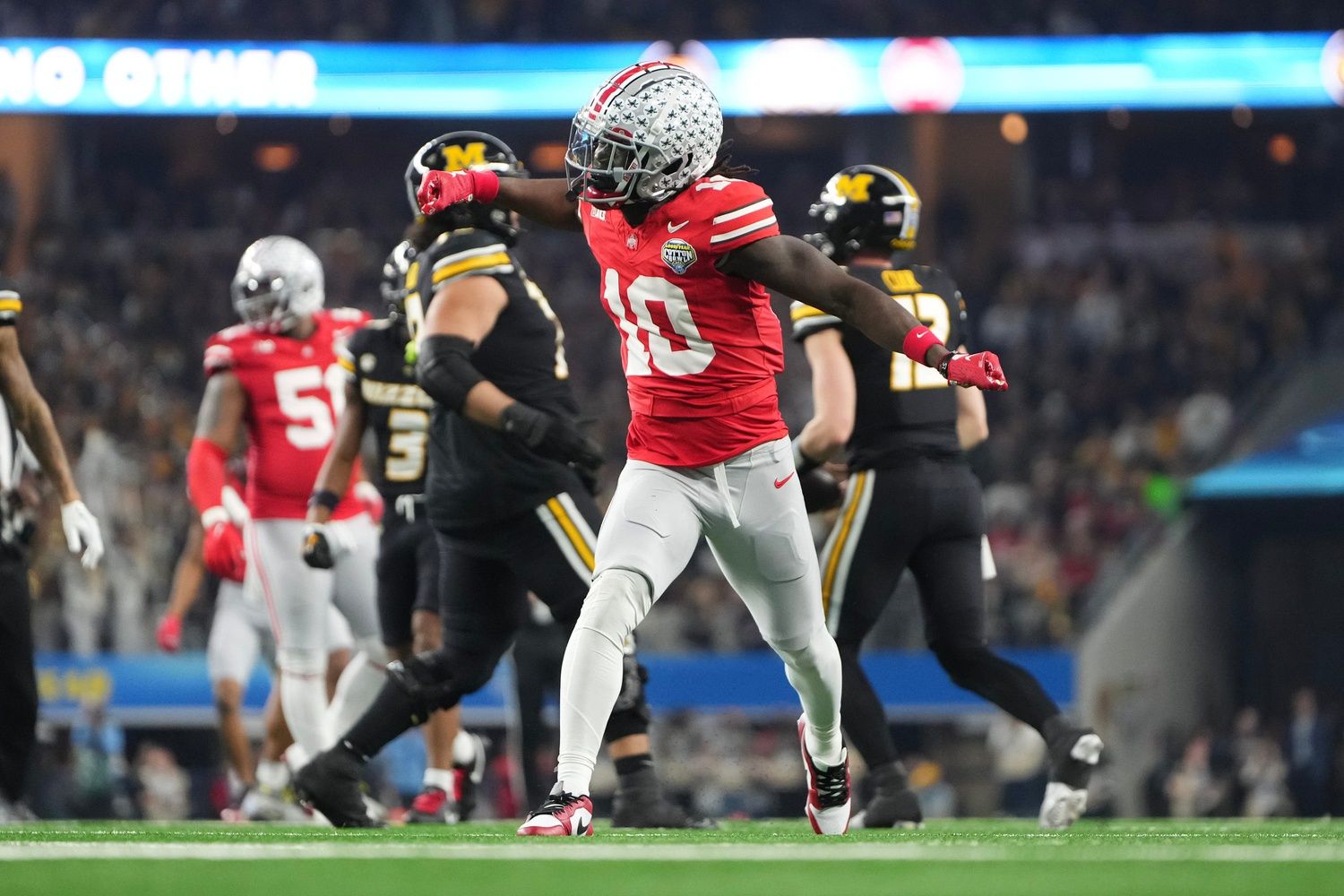 Ohio State Buckeyes cornerback Denzel Burke (10) celebrates a tackle during the first quarter of the Goodyear Cotton Bowl Classic against the Missouri Tigers at AT&T Stadium.