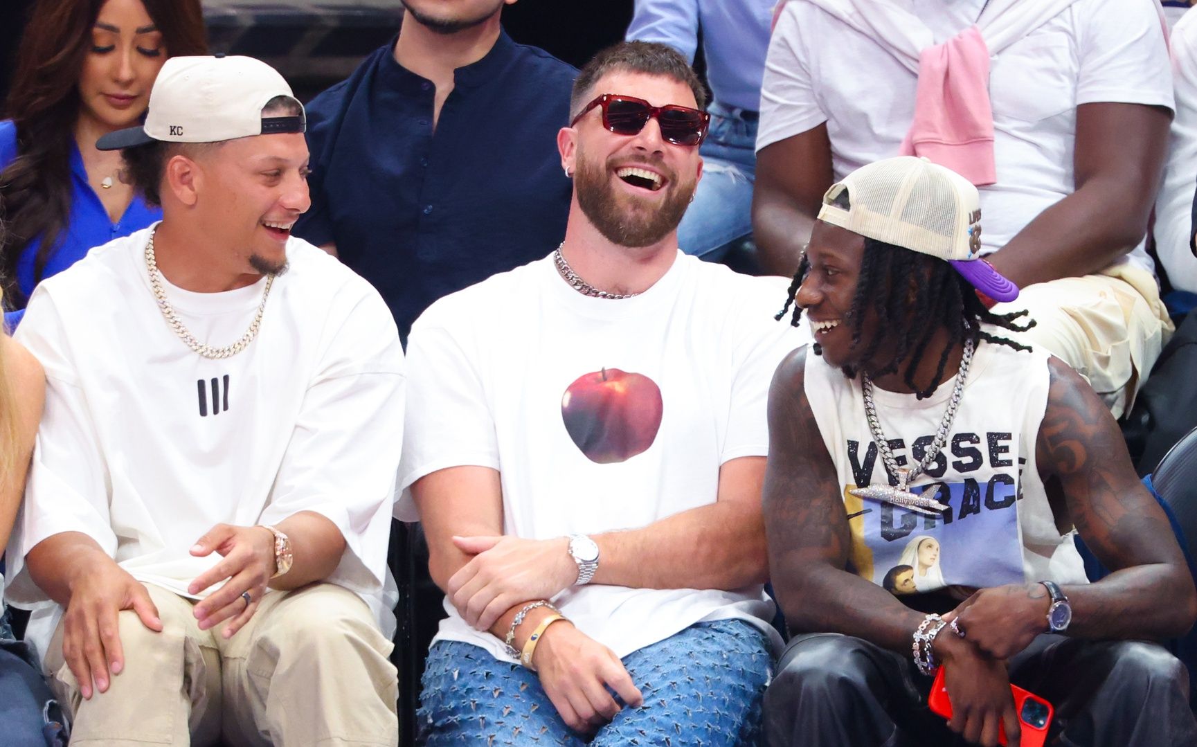 Kansas City Chiefs quarterback Patrick Mahomes II laughs with tight end Travis Kelce and wide receiver Marquis Hollywood Brown during the game between the Dallas Mavericks and Minnesota Timberwolves during game three of the western conference finals for the 2024 NBA playoffs at American Airlines Center.