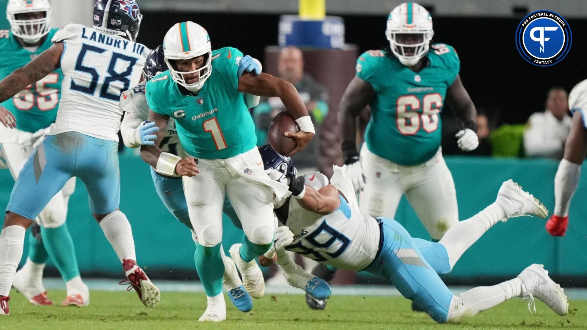 Miami Dolphins quarterback Tua Tagovailoa (1) gets taken down by Tennessee Titans safety Matthew Jackson (39) during the second half of an NFL game at Hard Rock Stadium in Miami Gardens, Dec. 11, 2023.