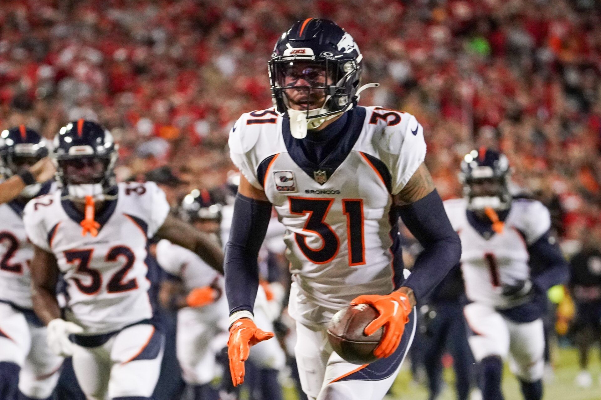 Denver Broncos safety Justin Simmons (31) celebrates after making an interception against the Kansas City Chiefs during the first half at GEHA Field at Arrowhead Stadium. Mandatory Credit: Denny Medley-USA TODAY Sports