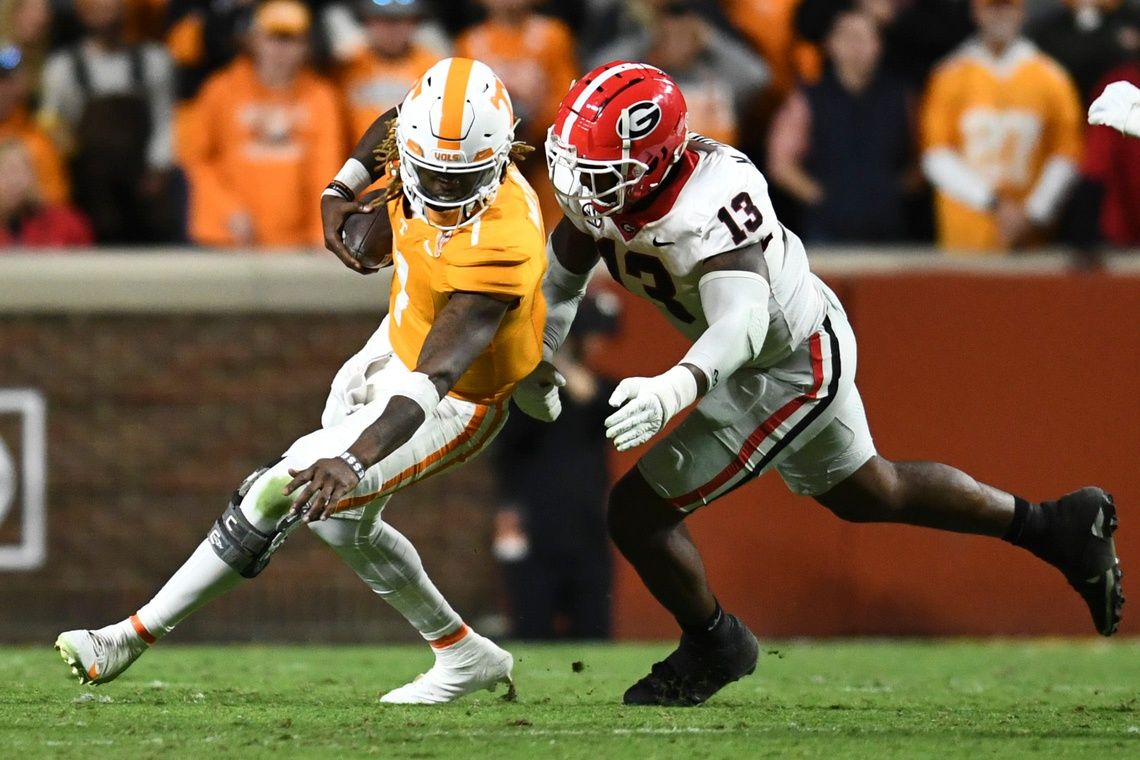 Tennessee quarterback Joe Milton III (7) is defended by Georgia defensive lineman Mykel Williams (13) during a football game between Tennessee and Georgia at Neyland Stadium in Knoxville, Tenn., on Saturday, Nov. 18, 2023.