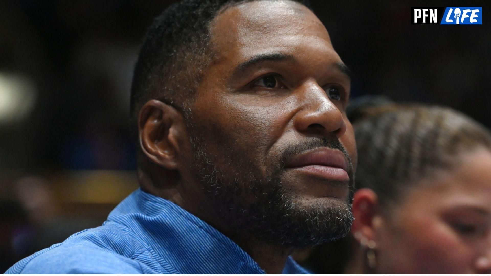 NFL Hall of Famer Michael Strahan looks on during a college basketball game.