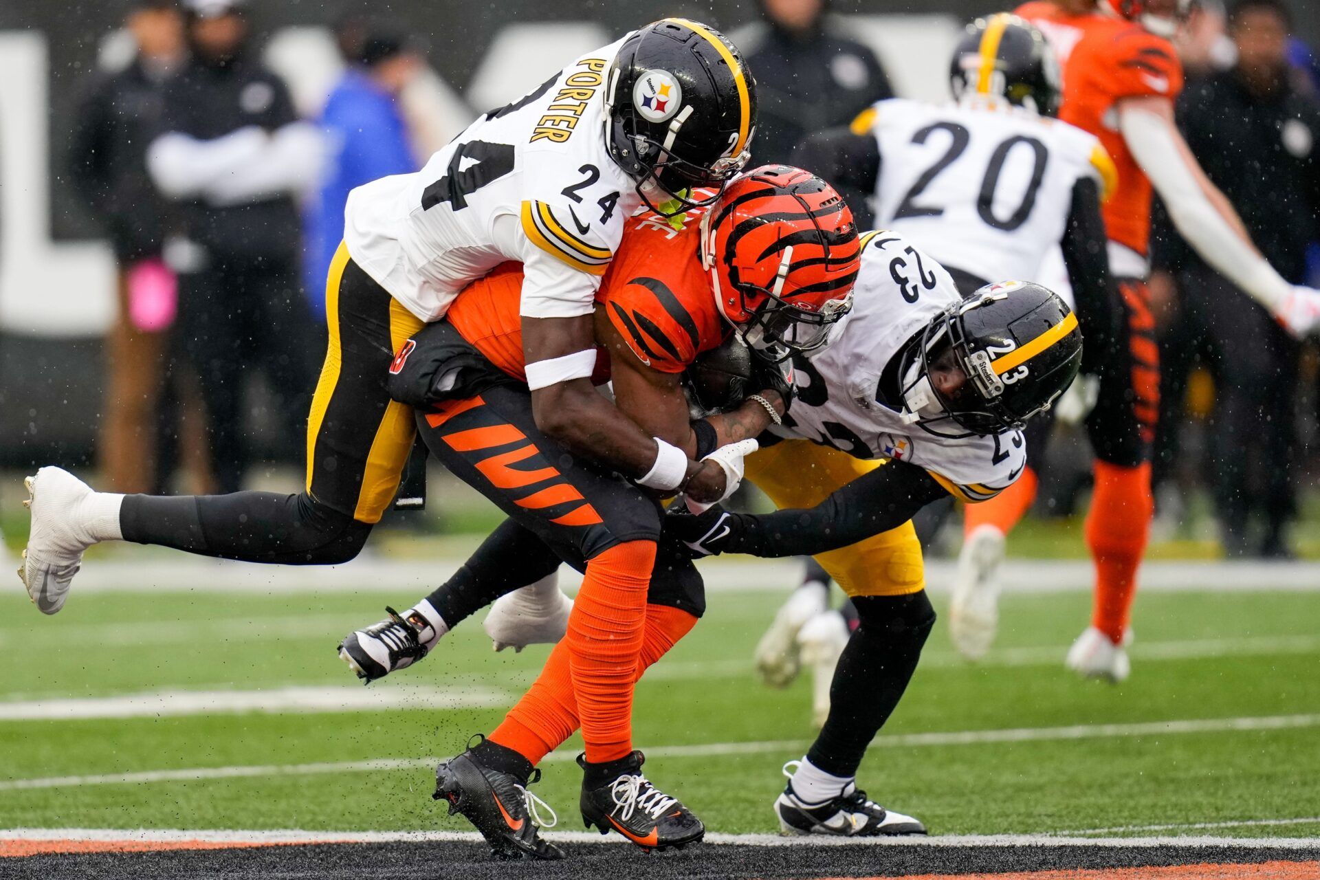 Cincinnati Bengals wide receiver Ja'Marr Chase (1) is pulled down by Pittsburgh Steelers cornerback Joey Porter Jr. (24) and safety Damontae Kazee (23) in the first quarter of the NFL Week 12 game between the Cincinnati Bengals and the Pittsburgh Steelers at Paycor Stadium in Cincinnati on Sunday, Nov. 26, 2023. Kazee spoke out against a potential 18-game NFL schedule to ESPN.