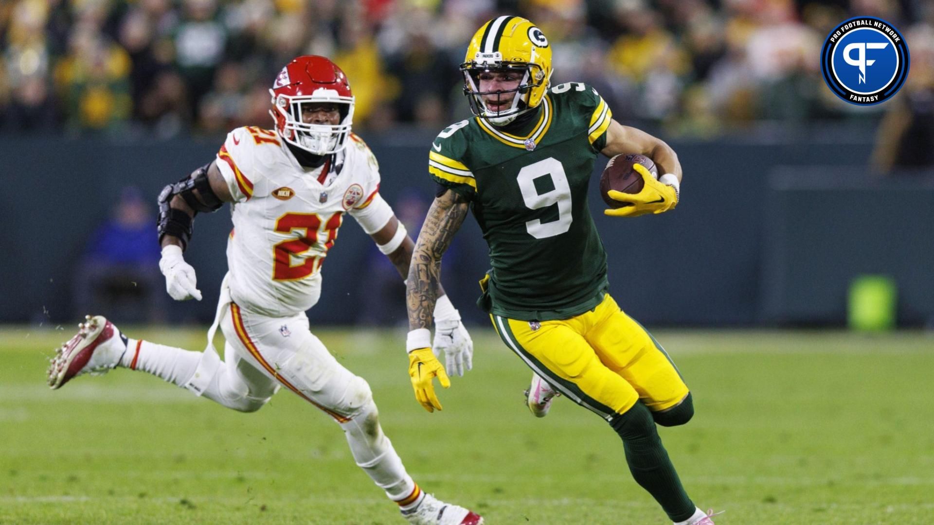 Green Bay Packers wide receiver Christian Watson (9) rushes with the football in front of Kansas City Chiefs safety Mike Edwards (21) during the fourth quarter at Lambeau Field. Mandatory Credit: Jeff Hanisch-USA TODAY Sports