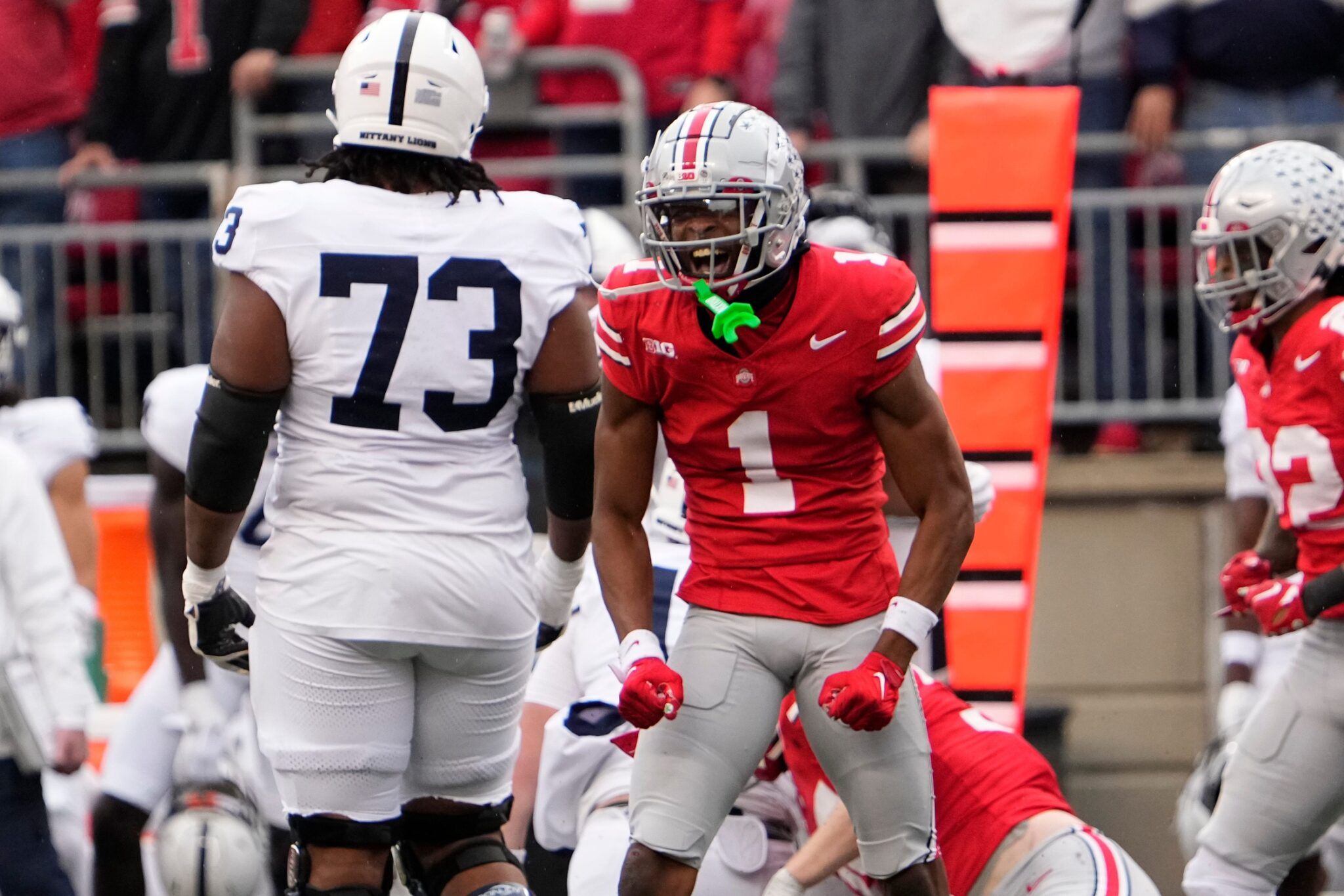 Ohio State Buckeyes cornerback Davison Igbinosun (1) celebrates in front of Penn State Nittany Lions offensive lineman Caedan Wallace (73) during the NCAA football game at Ohio Stadium.