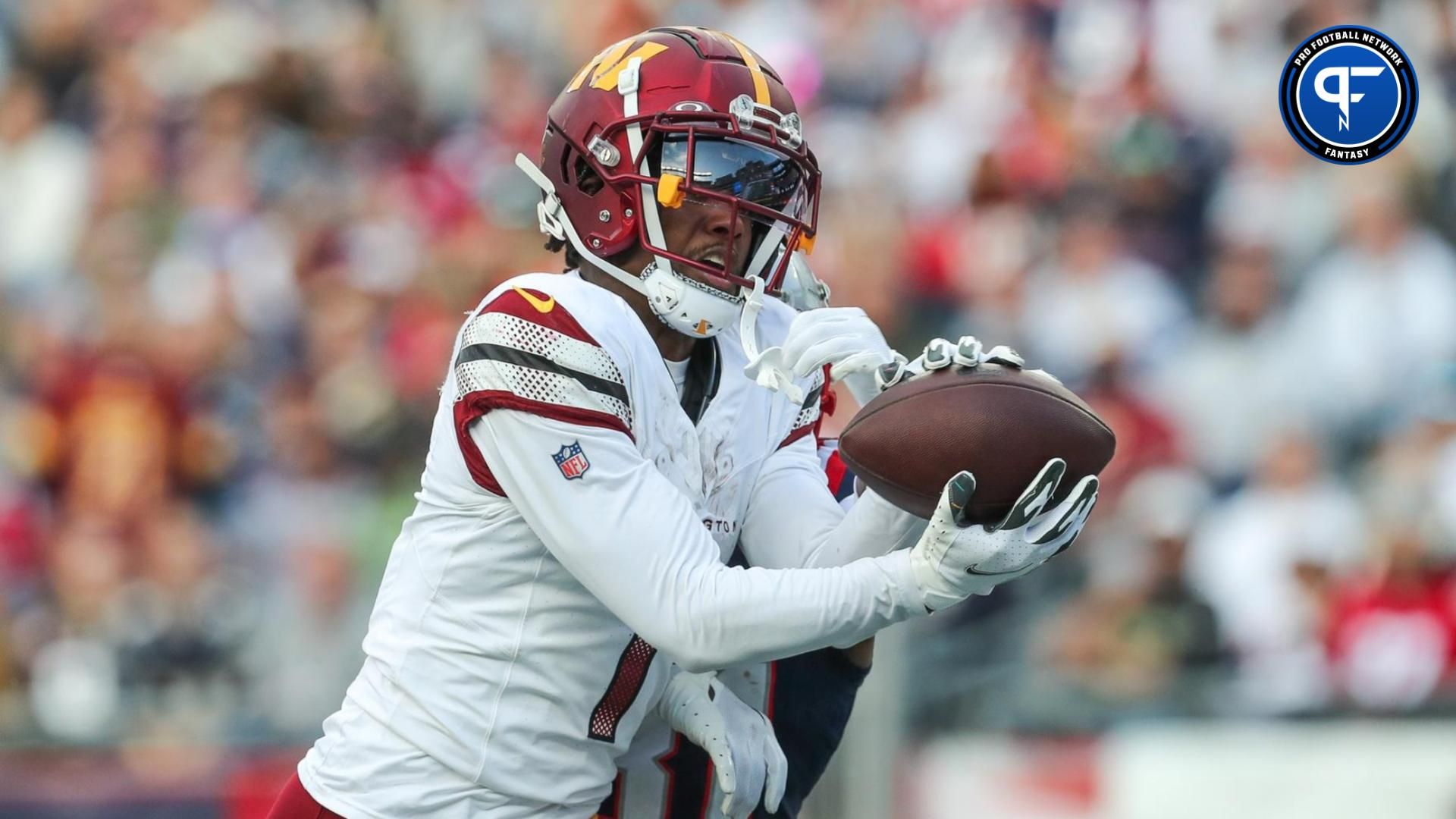 Washington Commanders receiver Jahan Dotson (1) catches a pass for a touchdown during the second half against the New England Patriots at Gillette Stadium. Mandatory Credit: Paul Rutherford-USA TODAY Sports