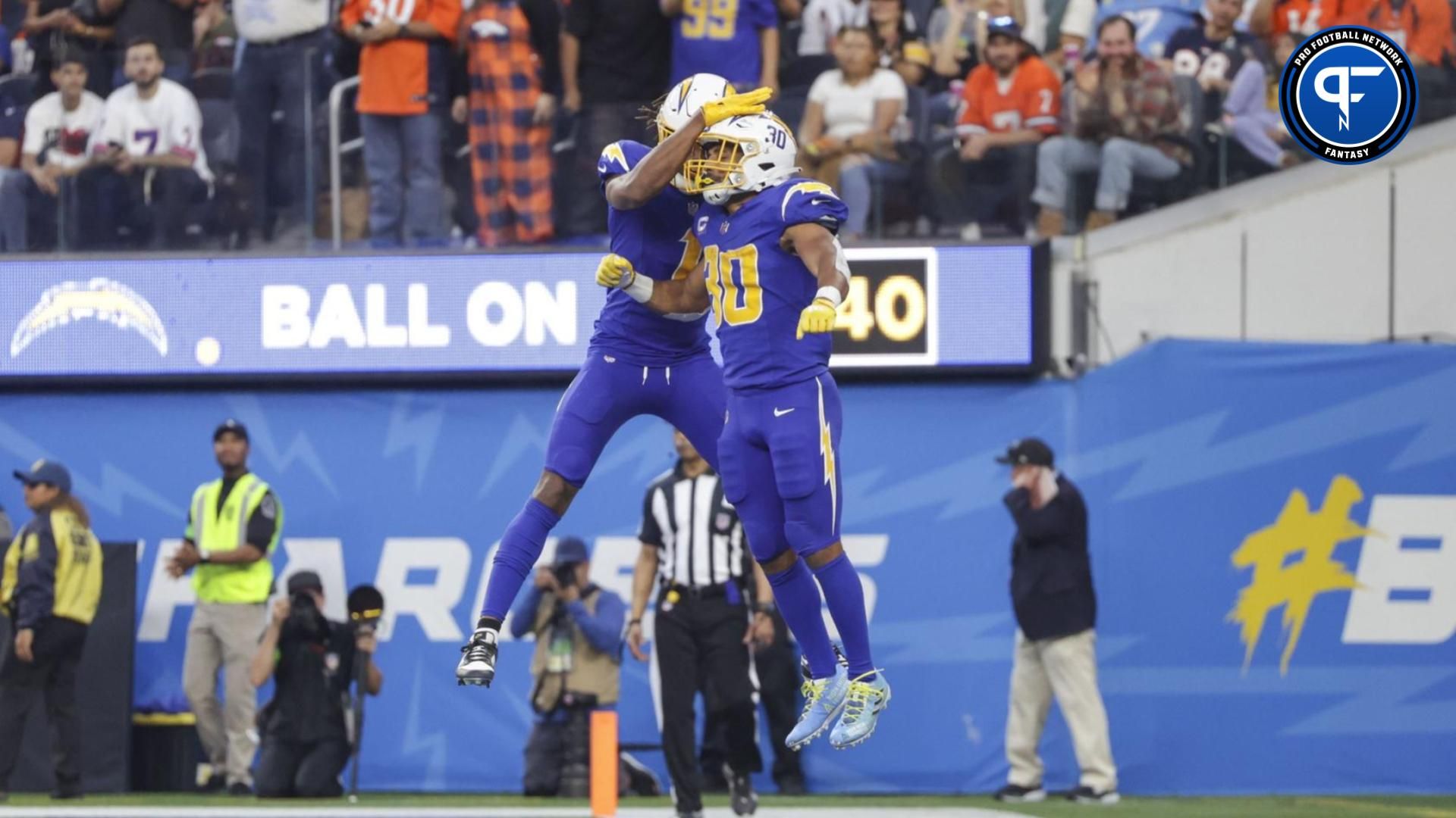 Los Angeles Chargers running back Austin Ekeler (30) celebrates with Los Angeles Chargers wide receiver Quentin Johnston (1) after scoring a touchdown during the second half in a game against the Denver Broncos at SoFi Stadium.