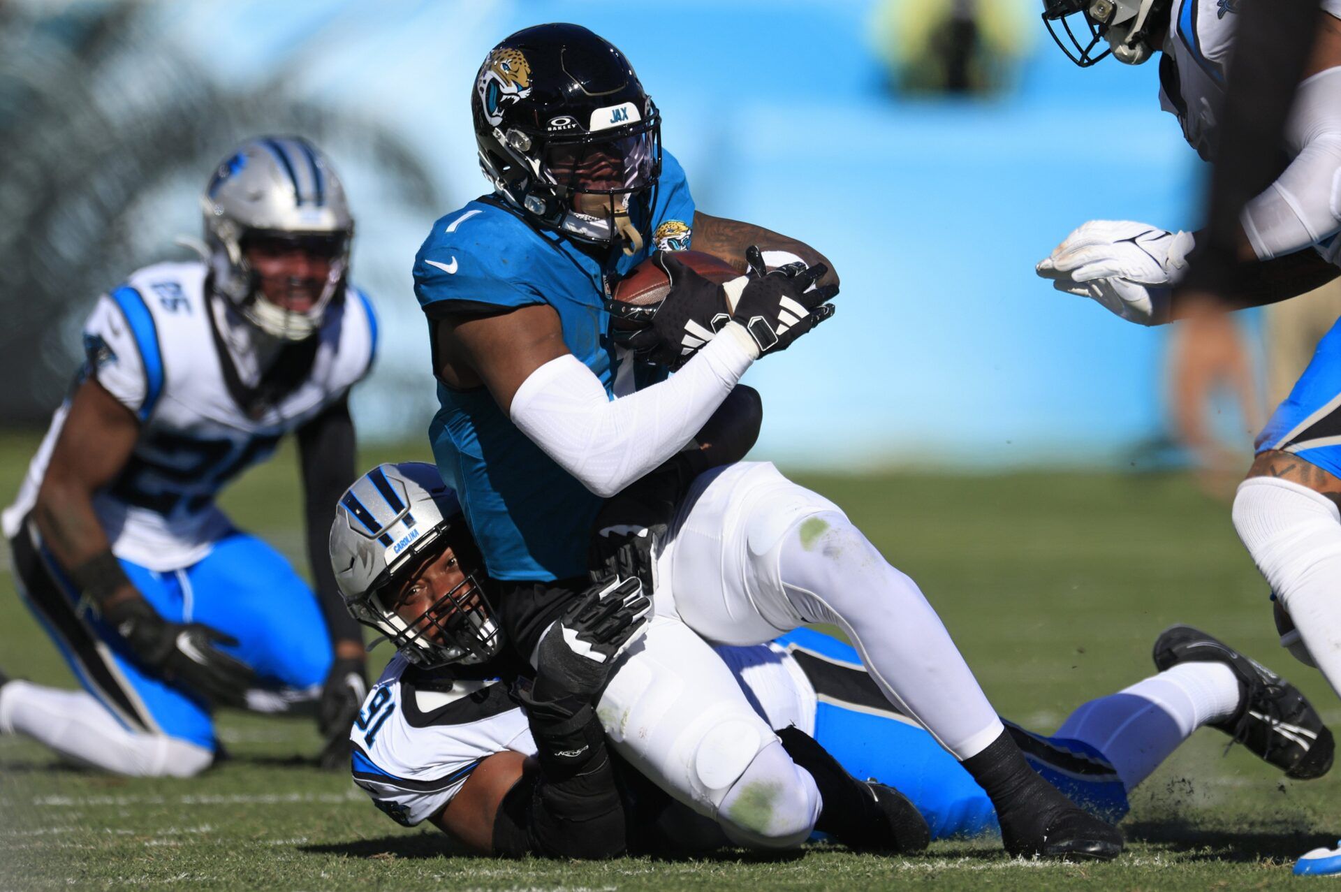 Carolina Panthers defensive end Nick Thurman (91) tackles Jacksonville Jaguars running back Travis Etienne Jr. (1) during the second quarter of a regular season NFL football matchup Sunday, Dec. 31, 2023 at EverBank Stadium in Jacksonville, Fla. The Jacksonville Jaguars blanked the Carolina Panthers 26-0.