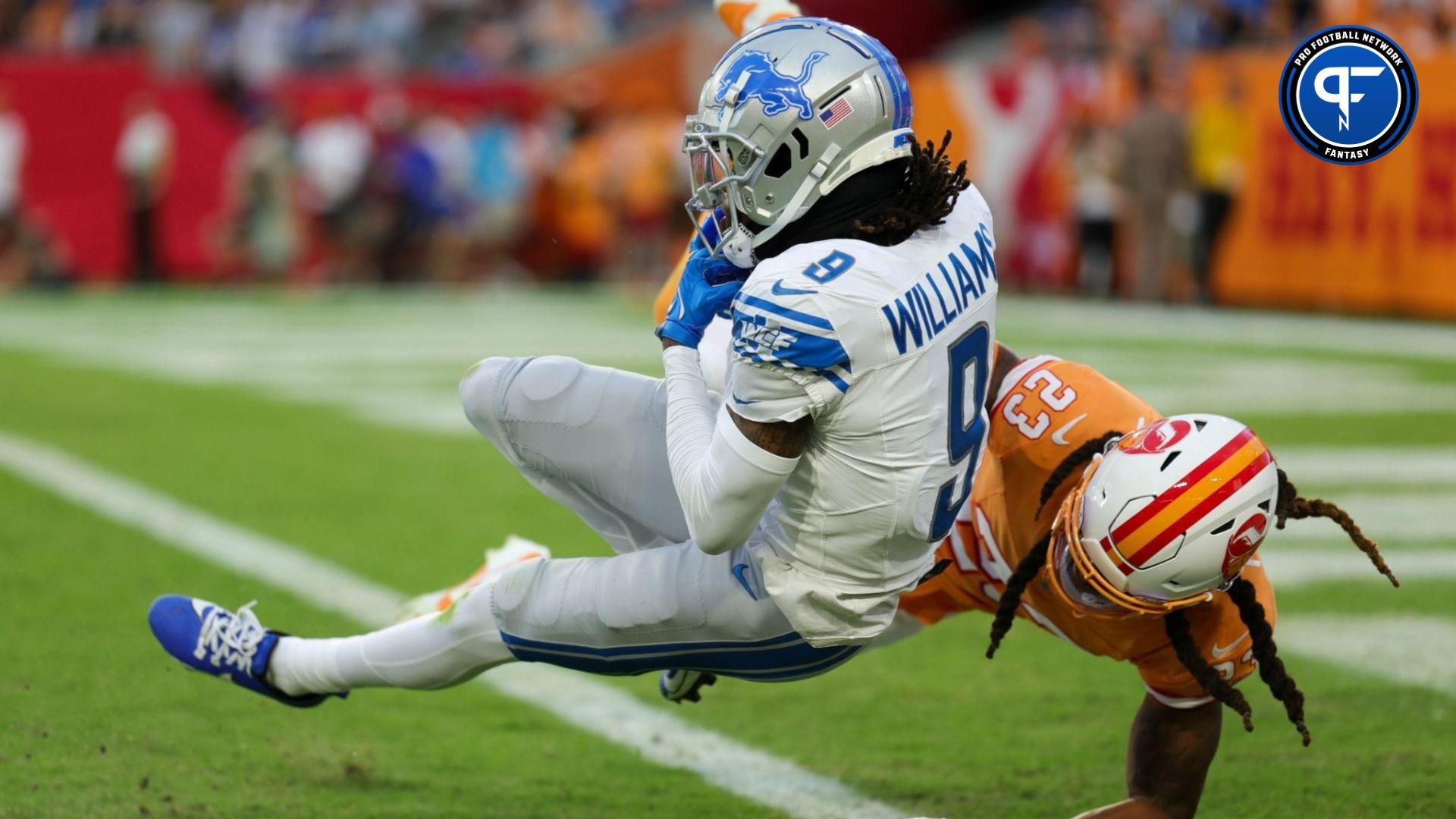 Detroit Lions wide receiver Jameson Williams (9) catches a pass for a touchdown defended by Tampa Bay Buccaneers safety Ryan Neal (23) in the third quarter at Raymond James Stadium.