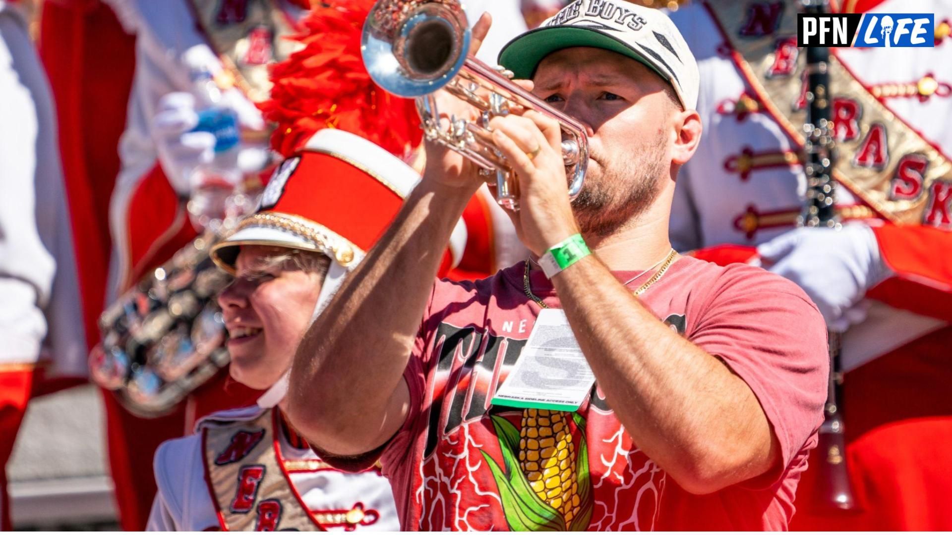 Sep 3, 2022; Lincoln, Nebraska, USA; Former Nebraska Cornhuskers linebacker and NFL free agent Will Compton holds a trumpet with the Cornhusker Marching Band before the game against the North Dakota Fighting Hawks at Memorial Stadium. Mandatory Credit: Dylan Widger-USA TODAY Sports