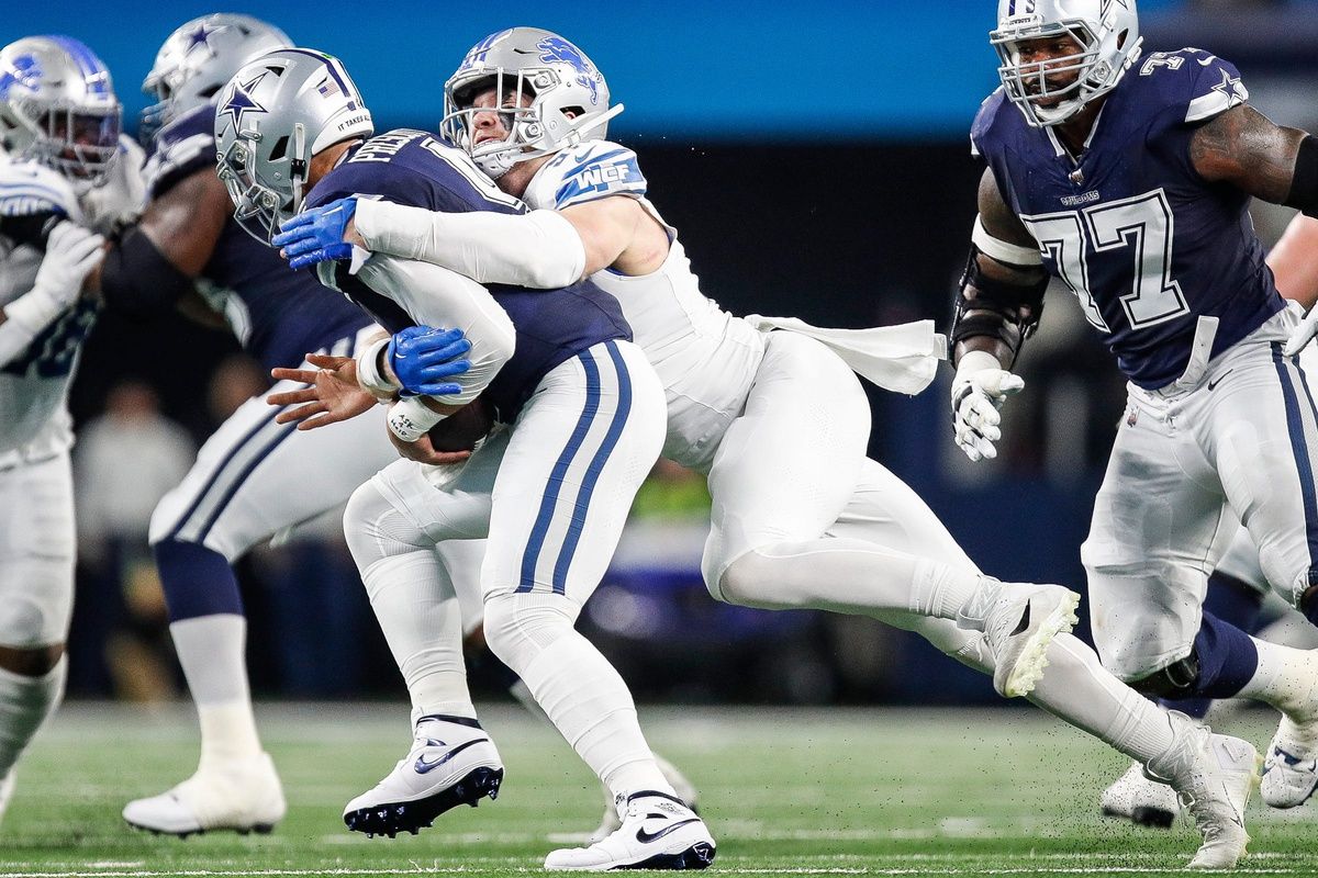 Dallas Cowboys QB Dak Prescott (4) is sacked by Detroit Lions DE Aidan Hutchinson (97).