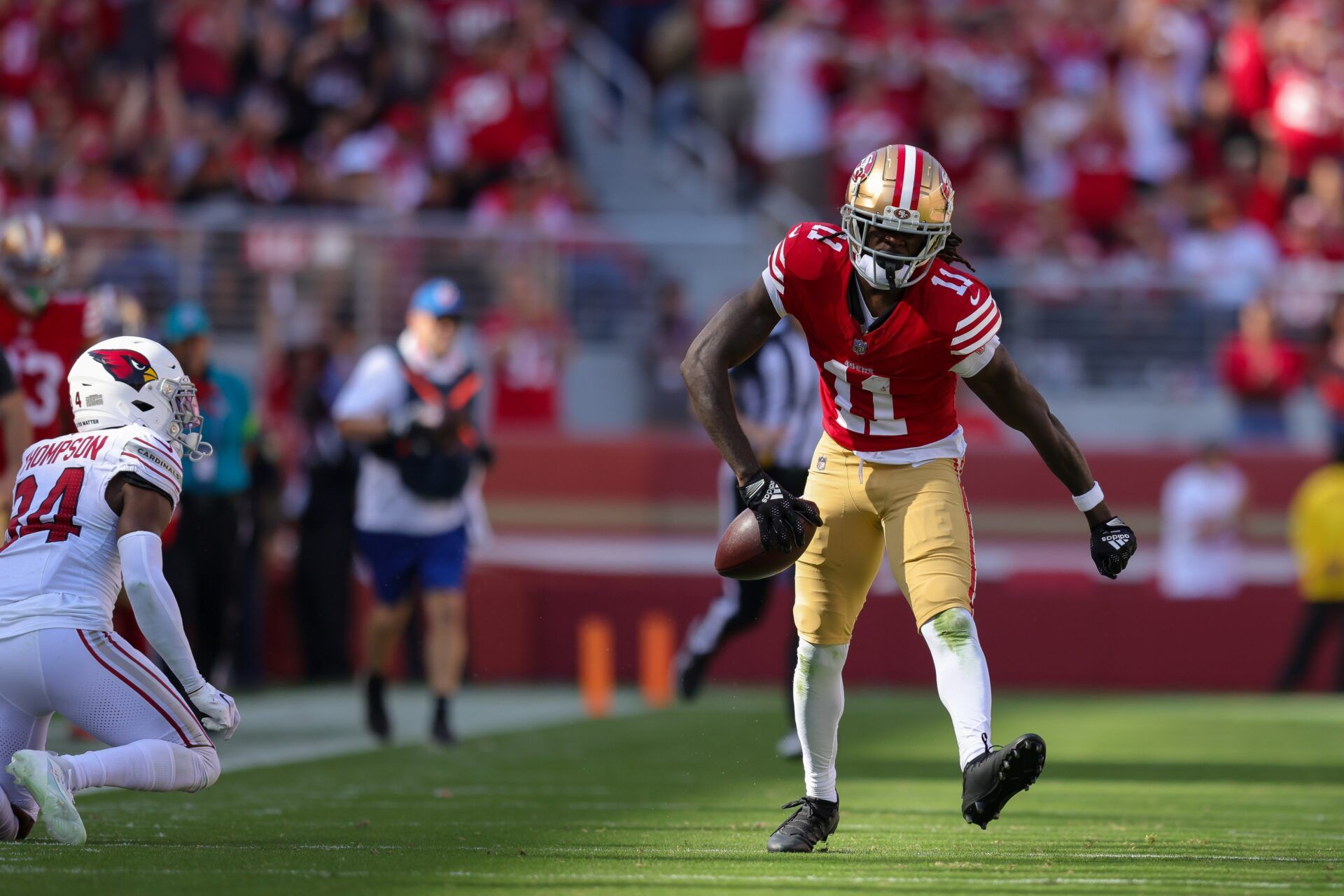 San Francisco 49ers wide receiver Brandon Aiyuk (11) celebrates after a play during the third quarter against the Arizona Cardinals at Levi's Stadium. Aiyuk is one of many potential NFL training camp holdouts as he seeks a new contract. Mandatory Credit: Sergio Estrada-USA TODAY Sports