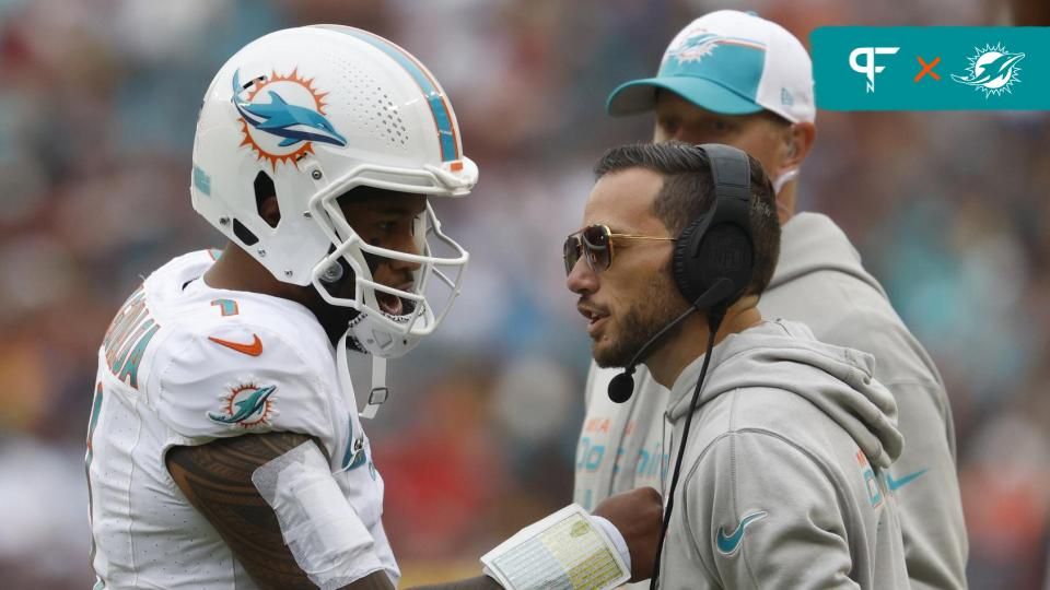 Miami Dolphins quarterback Tua Tagovailoa (1) talks with Dolphins head coach Mike McDaniel (R) during a timeout against the Washington Commanders during the second quarter at FedExField. Mandatory Credit: Geoff Burke-USA TODAY Sports