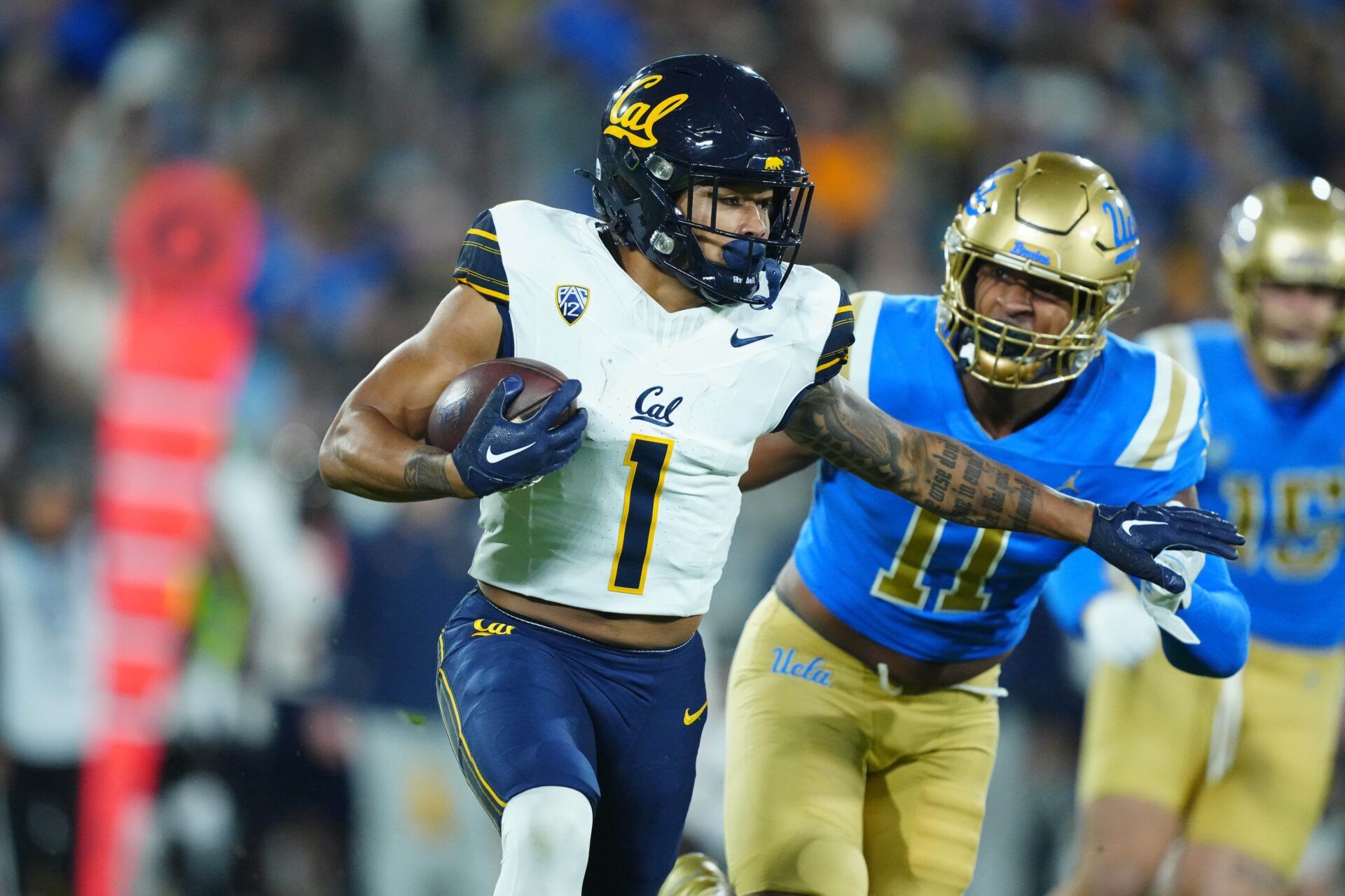 California Golden Bears running back Jaydn Ott (1) carries the ball against UCLA Bruins defensive lineman Gabriel Murphy (11) in the first half at Rose Bowl. Mandatory Credit: Kirby Lee-USA TODAY Sports