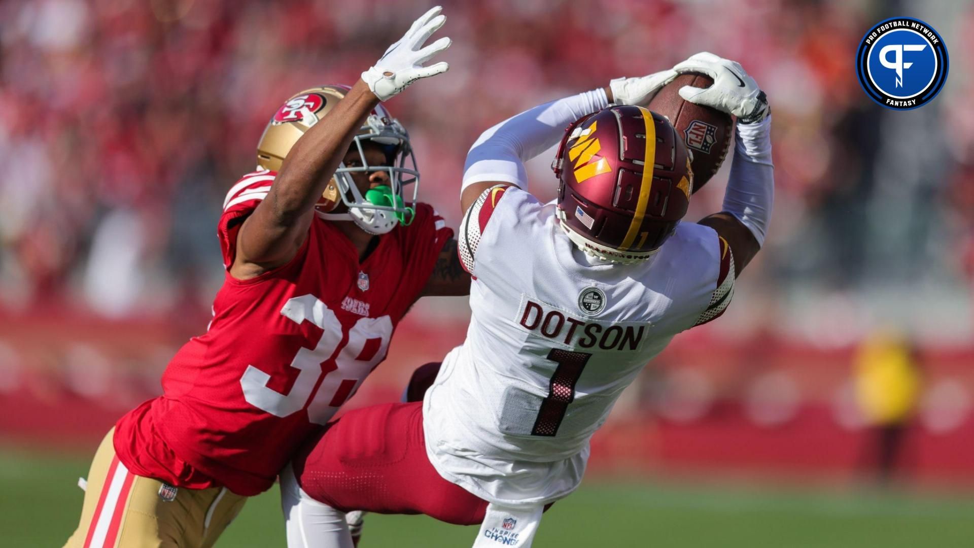 Washington Commanders wide receiver Jahan Dotson (1) makes a catch against San Francisco 49ers cornerback Deommodore Lenoir (38) during the second quarter. The play got called back due to penalties on both teams during the second quarter at Levi's Stadium.