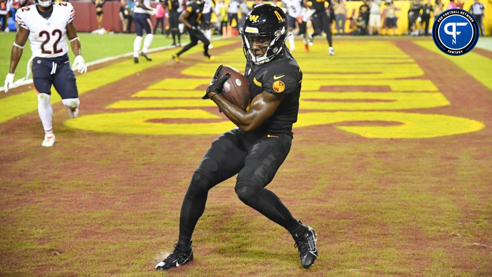 Washington Commanders wide receiver Curtis Samuel (4) scores a touchdown against the Chicago Bears during the second half at FedExField.