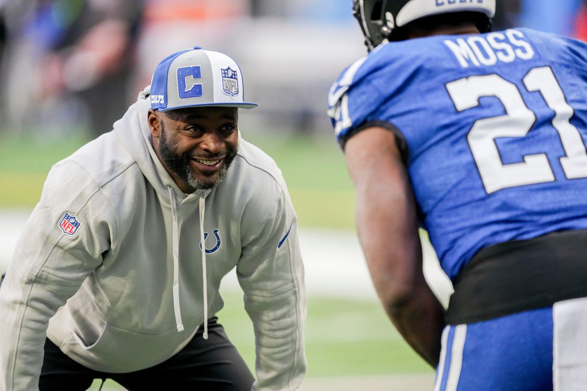 Indianapolis Colts wide receiver coach Reggie Wayne works with Indianapolis Colts running back Zack Moss (21) on Sunday, Oct. 22, 2023, before a game against the Cleveland Browns at Lucas Oil Stadium in Indianapolis.