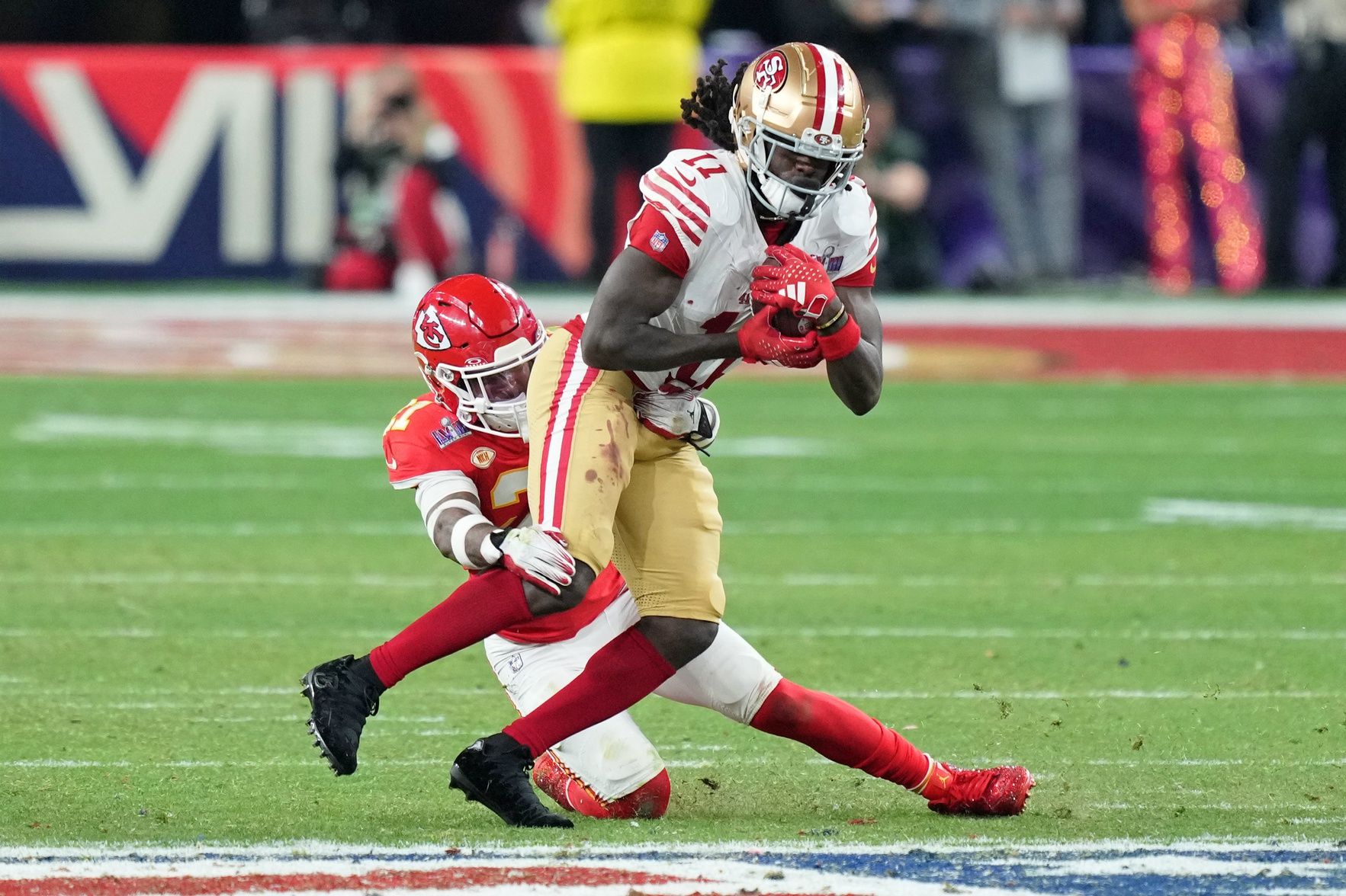 Kansas City Chiefs safety Mike Edwards (21) tackles San Francisco 49ers wide receiver Brandon Aiyuk (11) during overtime of Super Bowl LVIII at Allegiant Stadium.