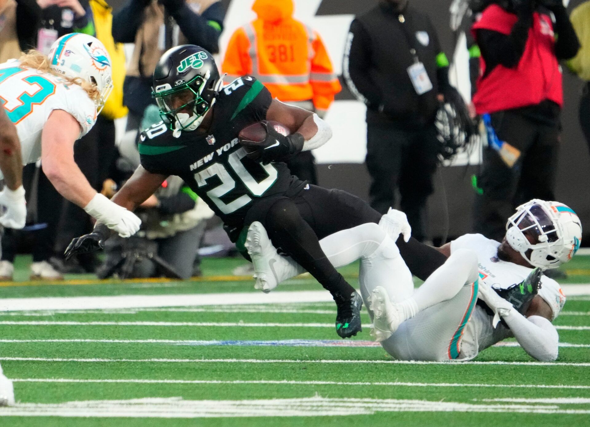 New York Jets running back Breece Hall (20) is stopped by Miami Dolphins cornerback Kader Kohou (4) in the second quarter at MetLife Stadium. After 