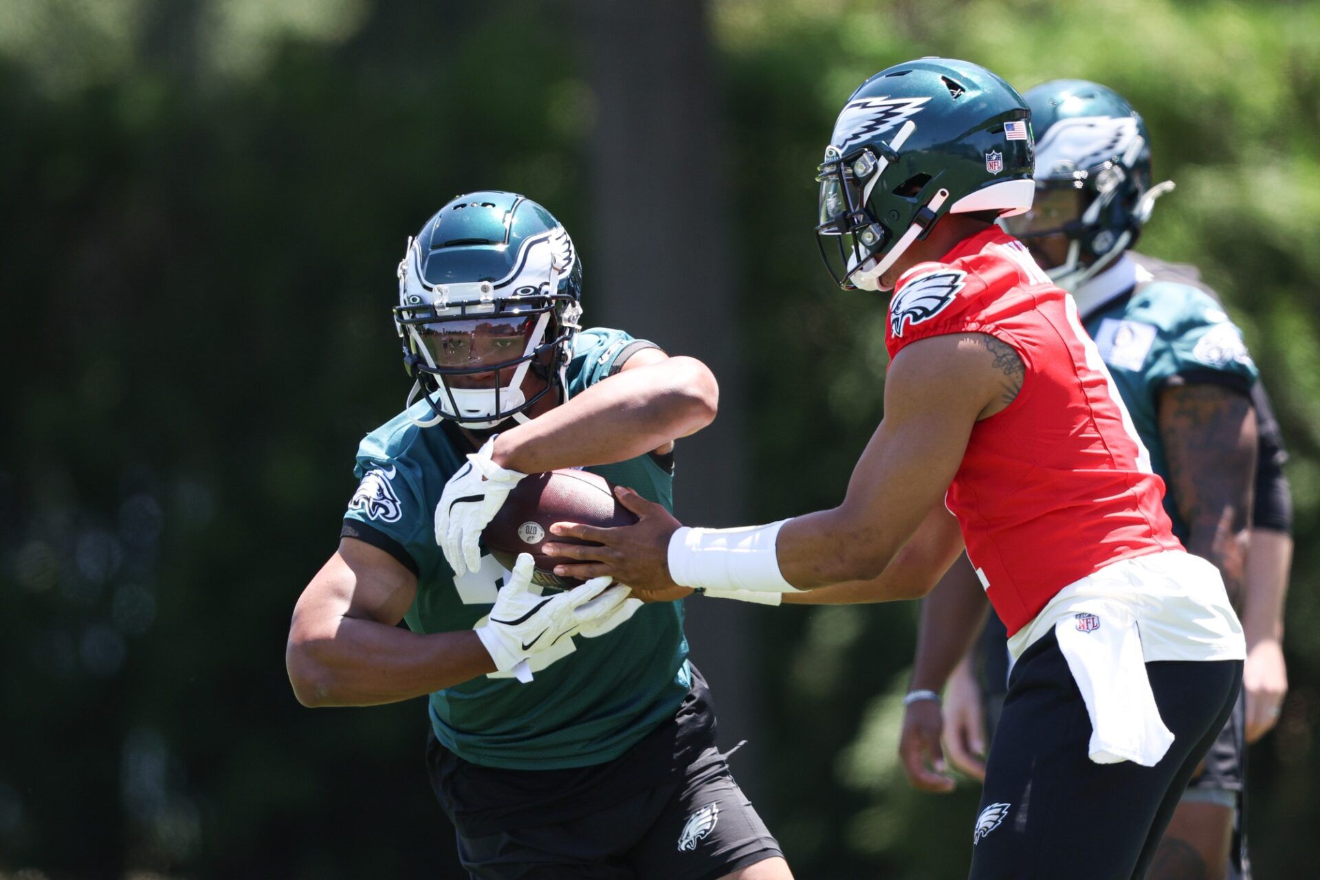 Philadelphia Eagles quarterback Jalen Hurts (1) hands off to running back Saquon Barkley (26) during practice at NovaCare Complex.