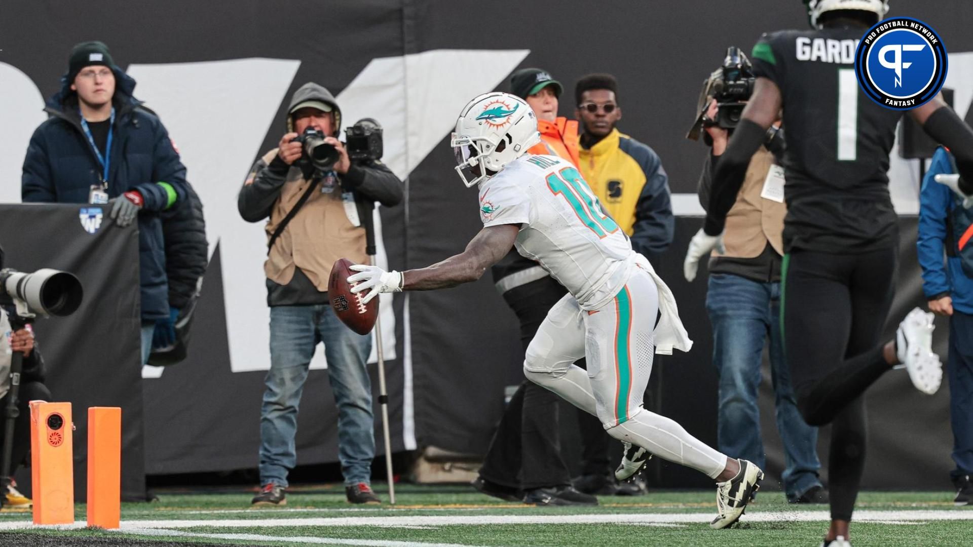 Miami Dolphins wide receiver Tyreek Hill (10) scores a receiving touchdown during the first half in front of New York Jets cornerback Sauce Gardner (1) at MetLife Stadium.