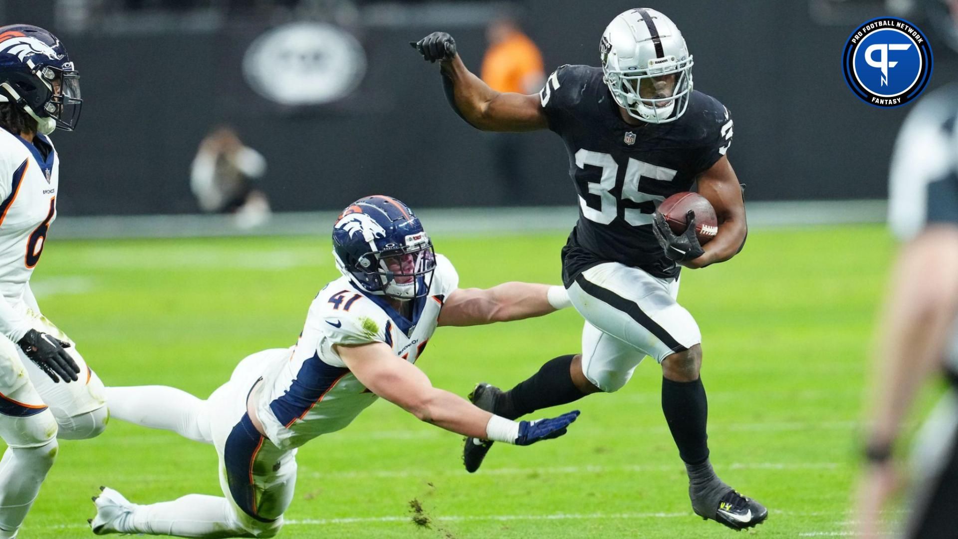 Las Vegas Raiders running back Zamir White (35) is pushed out of bounds by Denver Broncos linebacker Drew Sanders (41) during the second quarter at Allegiant Stadium.