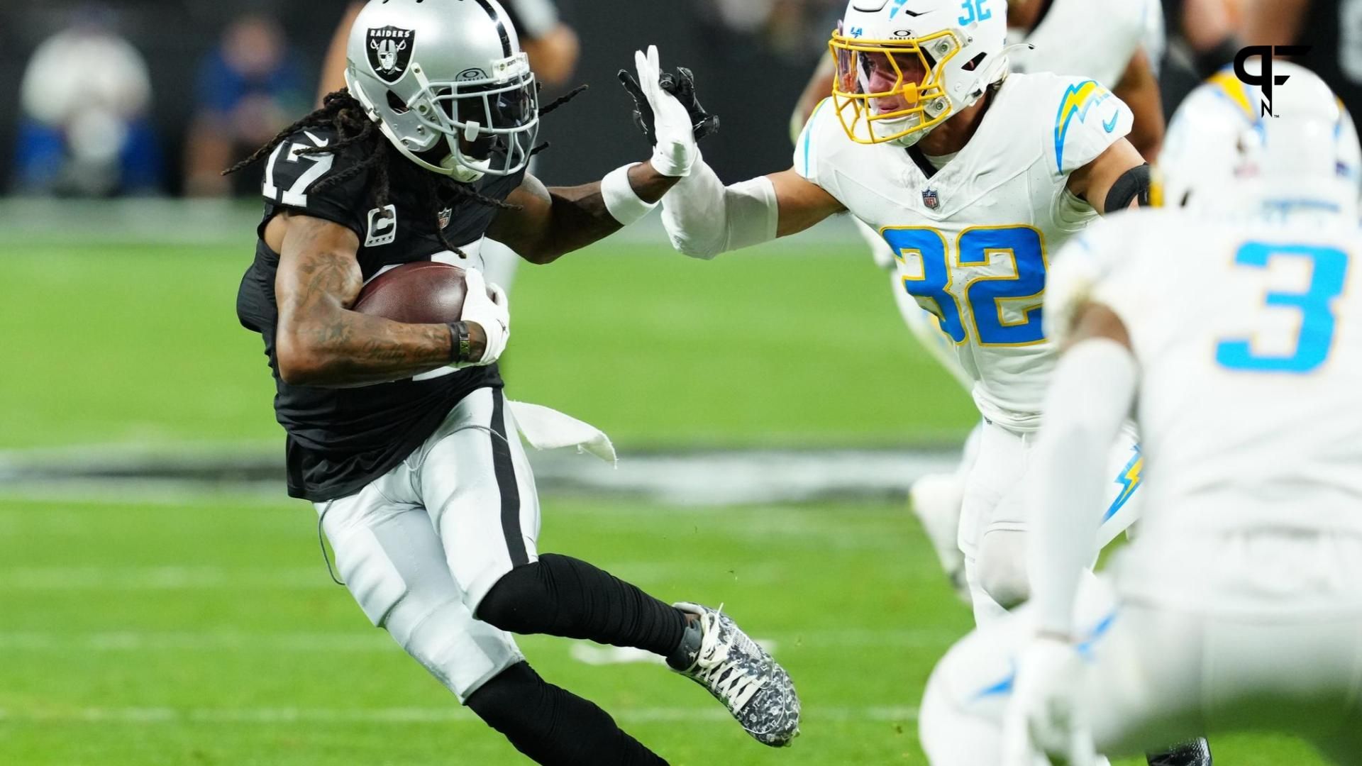 Las Vegas Raiders wide receiver Davante Adams (17) runs against Los Angeles Chargers safety Alohi Gilman (32) in the first quarter at Allegiant Stadium.