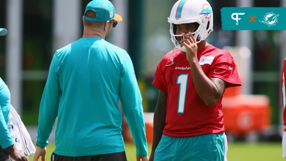 Miami Dolphins quarterback Tua Tagovailoa (1) talks to quarterback coach Darrell Bevell during mandatory minicamp at Baptist Health Training Complex.