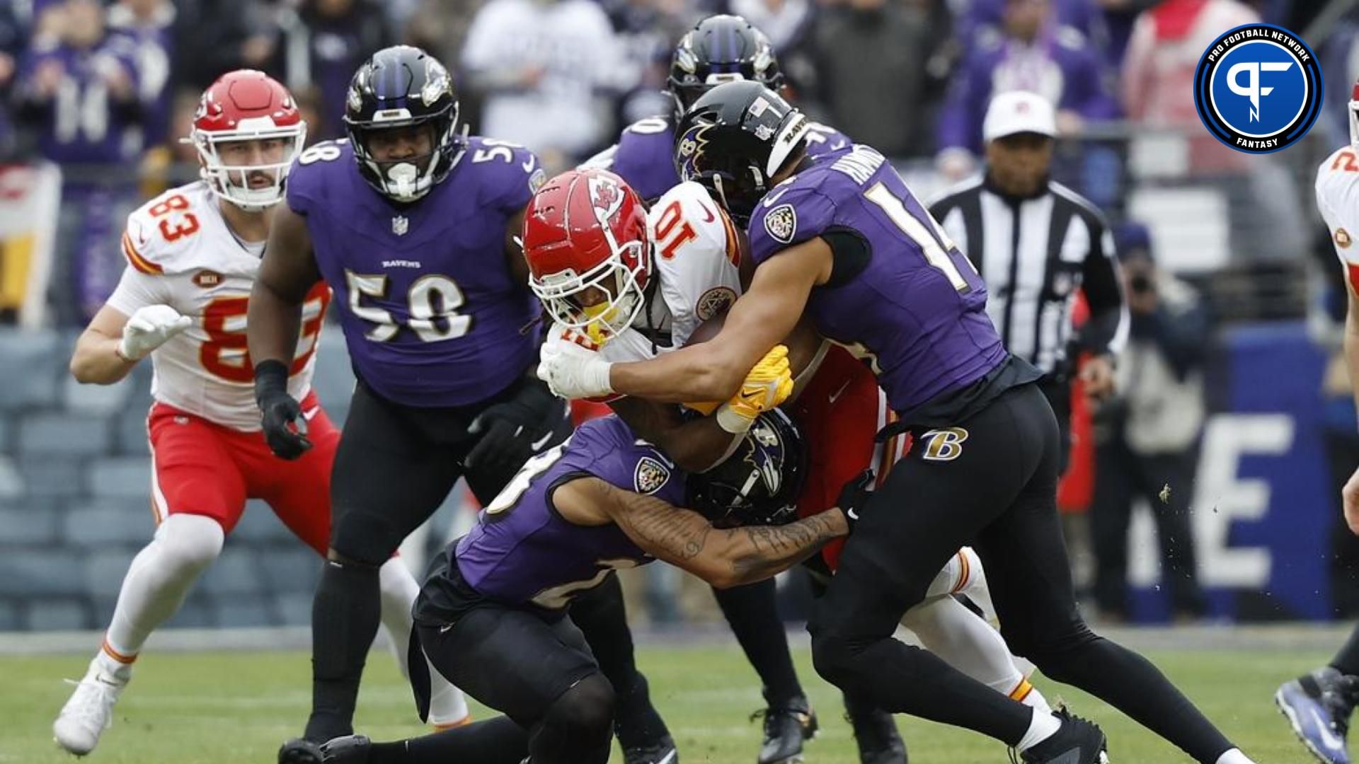 Kansas City Chiefs running back Isiah Pacheco (10) carries the ball as Baltimore Ravens safety Kyle Hamilton (14) defends during the first half in the AFC Championship football game at M&T Bank Stadium. Mandatory Credit: Geoff Burke-USA TODAY Sports