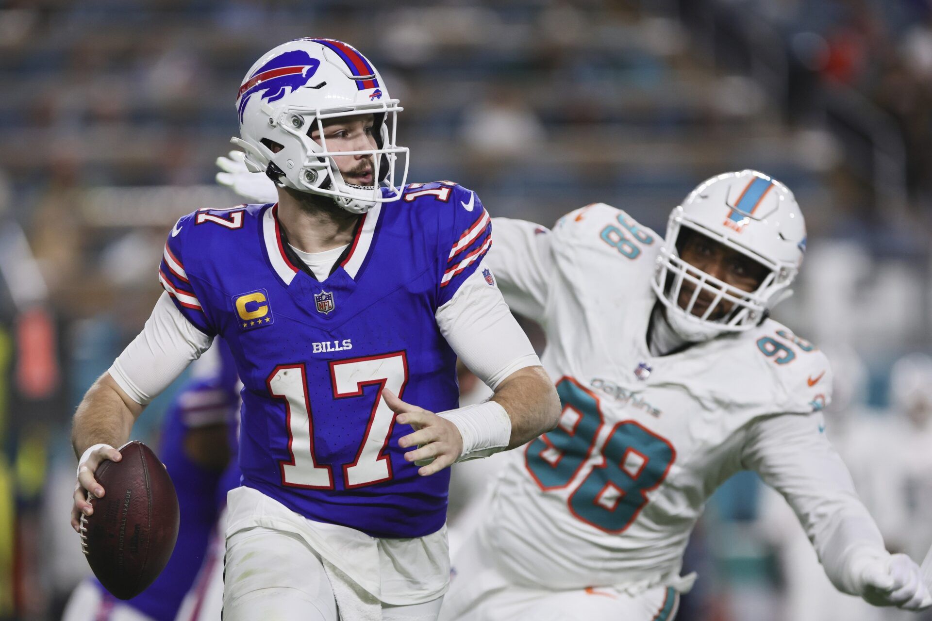 Buffalo Bills quarterback Josh Allen (17) runs with the football against the Miami Dolphins during the second quarter at Hard Rock Stadium in an AFC East clash. Mandatory Credit: Sam Navarro-USA TODAY Sports