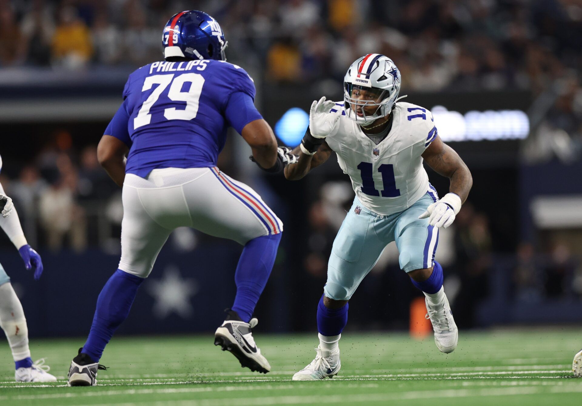 Dallas Cowboys linebacker Micah Parsons (11) rushes against New York Giants offensive tackle Tyre Phillips (79) during the game at AT&T Stadium in an NFC East clash. Mandatory Credit: Kevin Jairaj-USA TODAY Sports