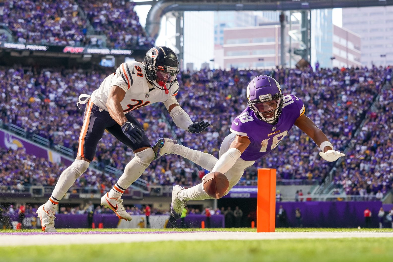 Minnesota Vikings wide receiver Justin Jefferson (18) dives for a 2 point conversion against the Chicago Bears cornerback Jaylon Jones (31) in the fourth quarter at U.S. Bank Stadium in an NFC North clash. Mandatory Credit: Brad Rempel-USA TODAY Sports