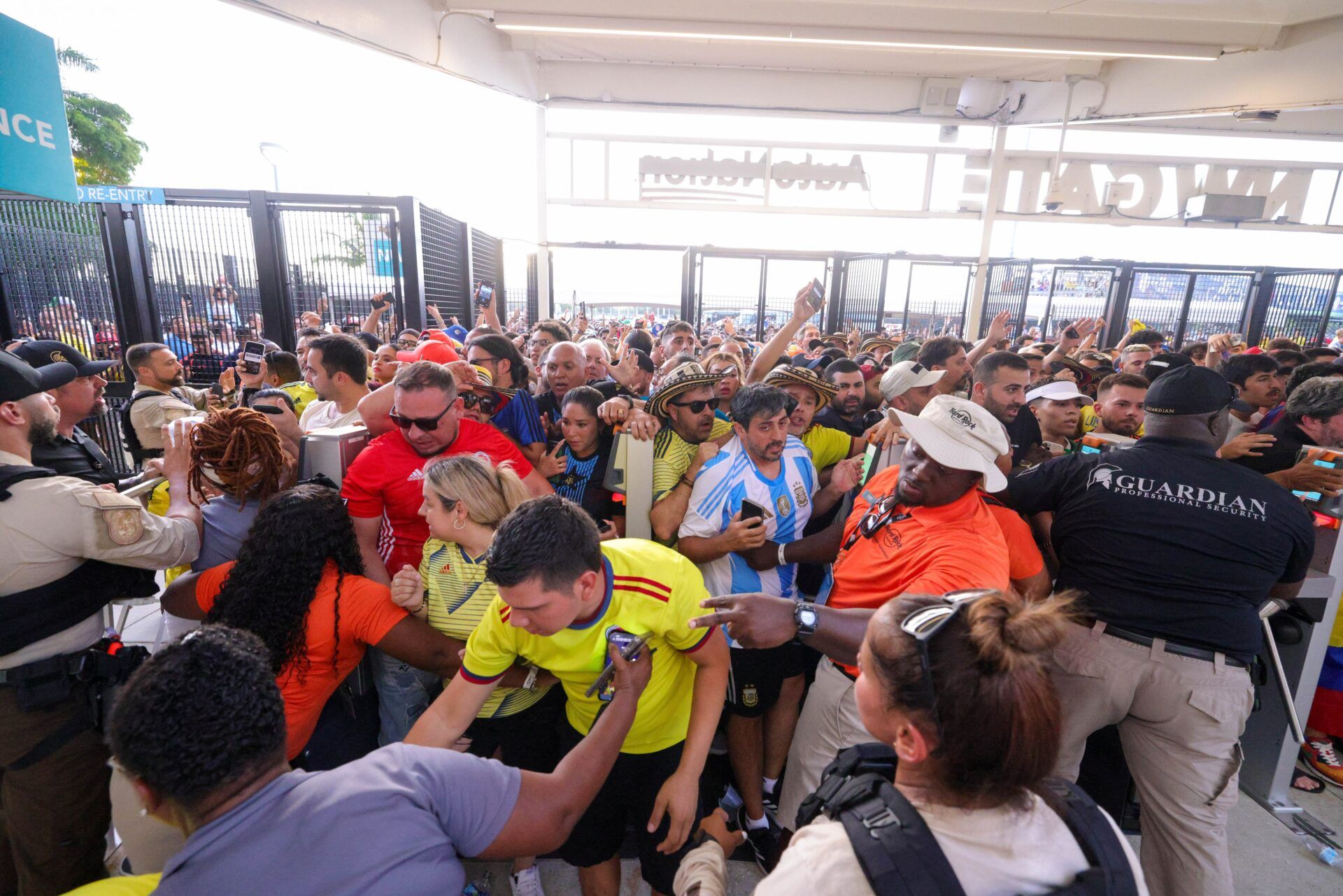 Fans rush the gates before the Copa America Final match between Argentina and Colombia at Hard Rock Stadium.