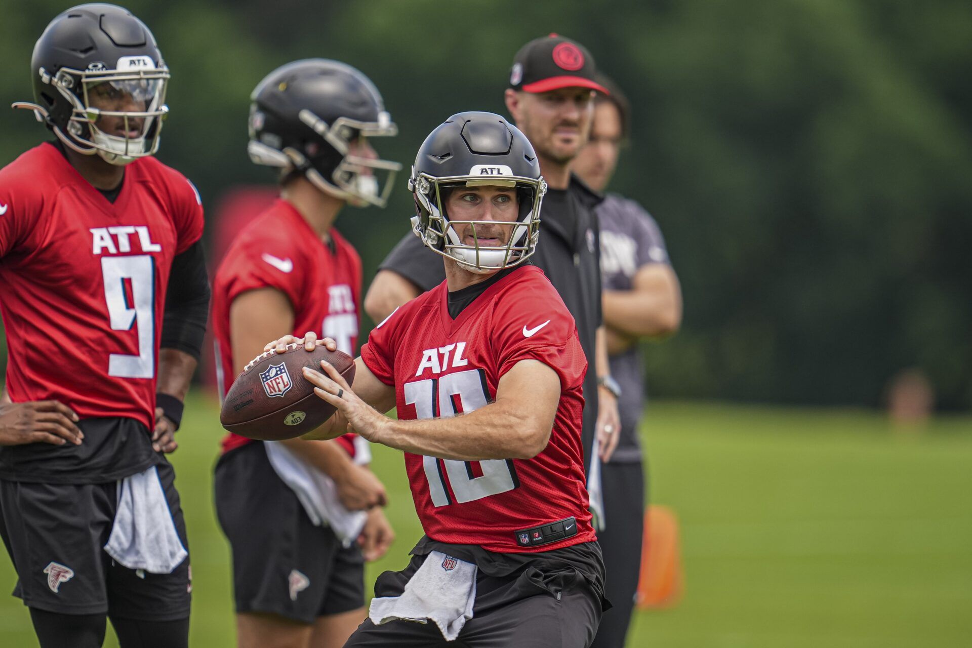 Atlanta Falcons quarterback Kirk Cousins (18) throws while quarterback Michael Penix Jr (9) watches on the field during Falcons OTA at the Falcons Training facility. Mandatory Credit: Dale Zanine-USA TODAY Sports